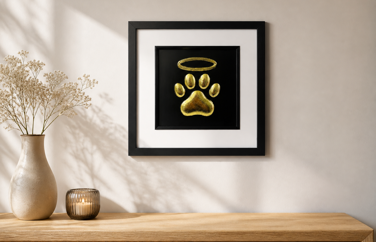 Dog memorial paw print wall art in a black frame styled in a calm home setting