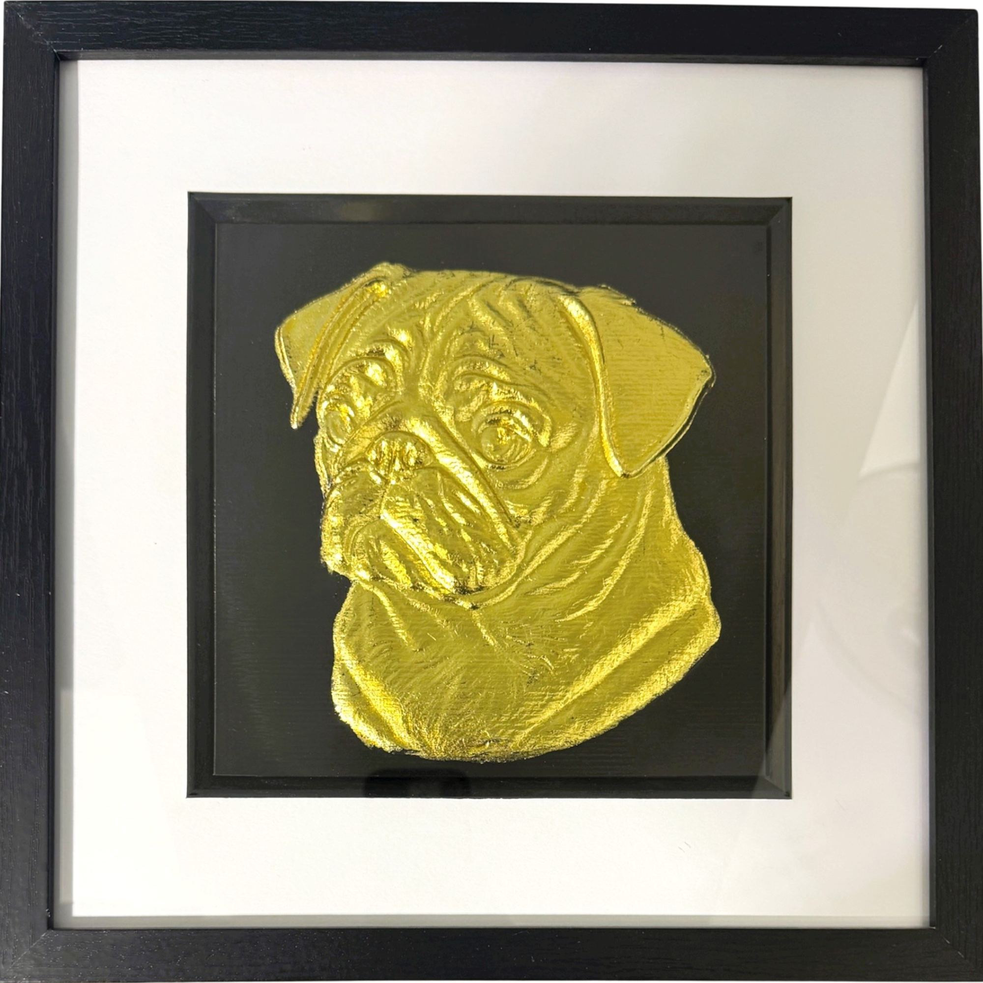 Handmade framed gold leaf wall art featuring a Pug, set on a black background with white mount and black frame.