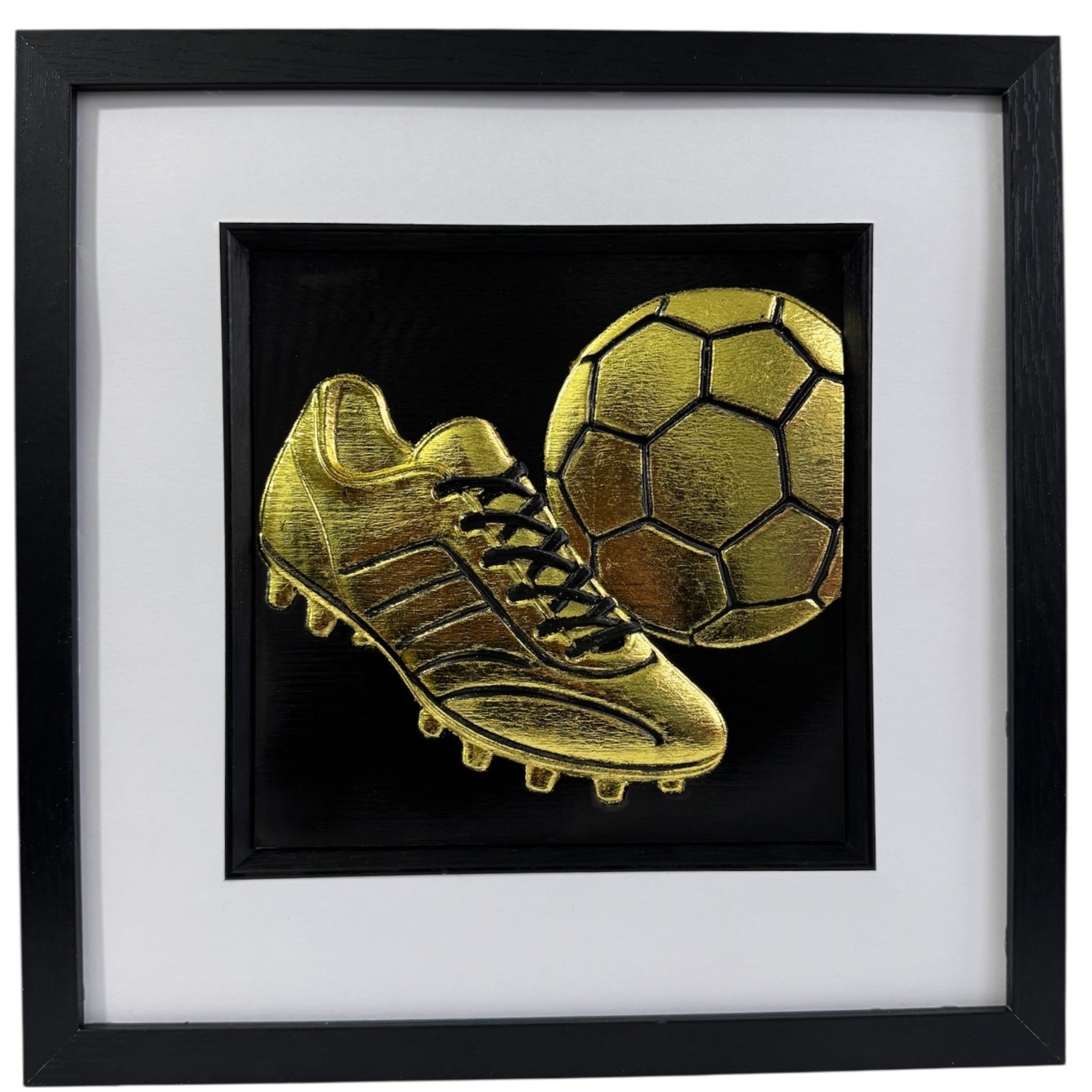 Football wall art featuring a gold 3D football boot and ball in a black frame with white mount