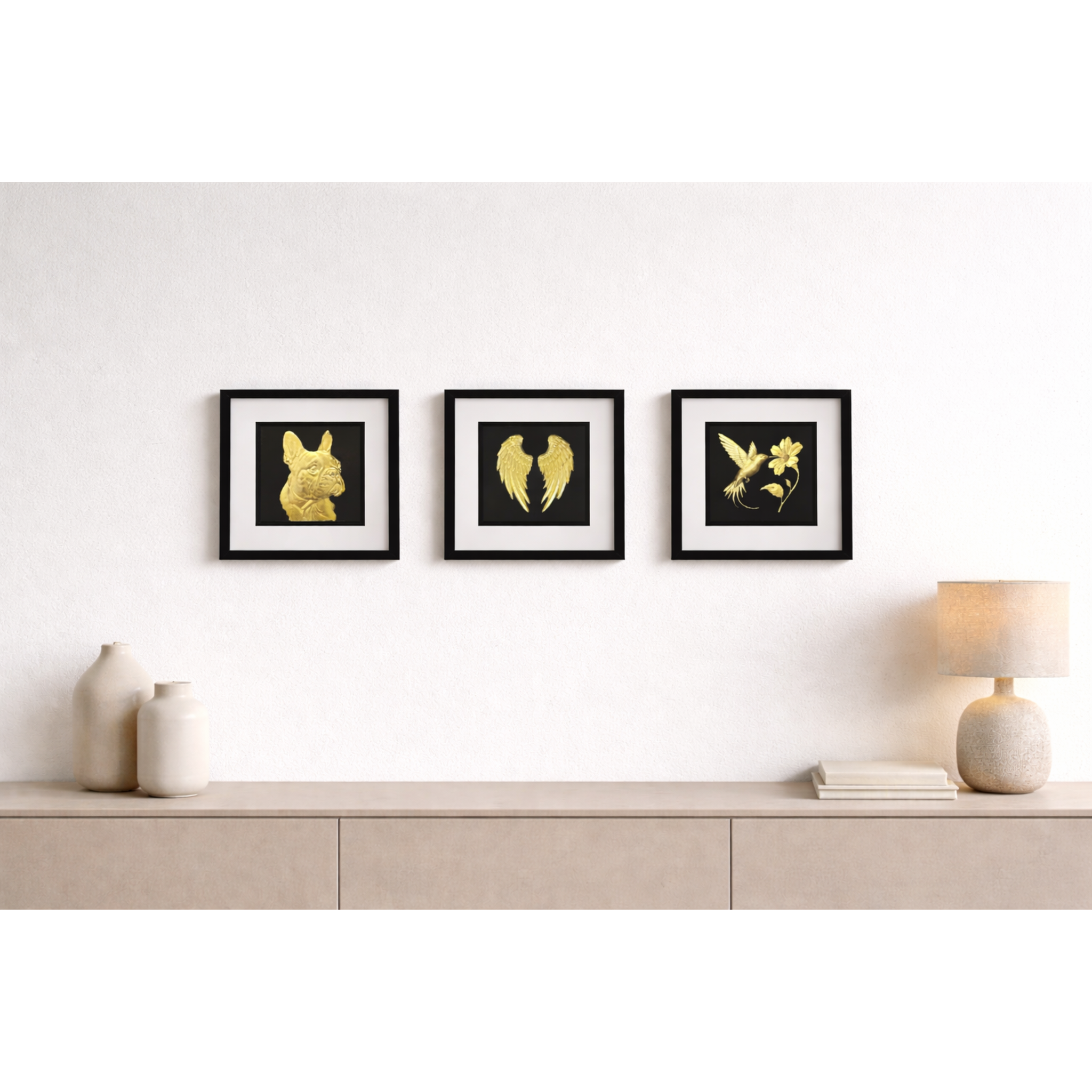 Set of three handmade 3D gold leaf wall art frames featuring a French Bulldog, Angel Wings, and Hummingbird in a modern living room.