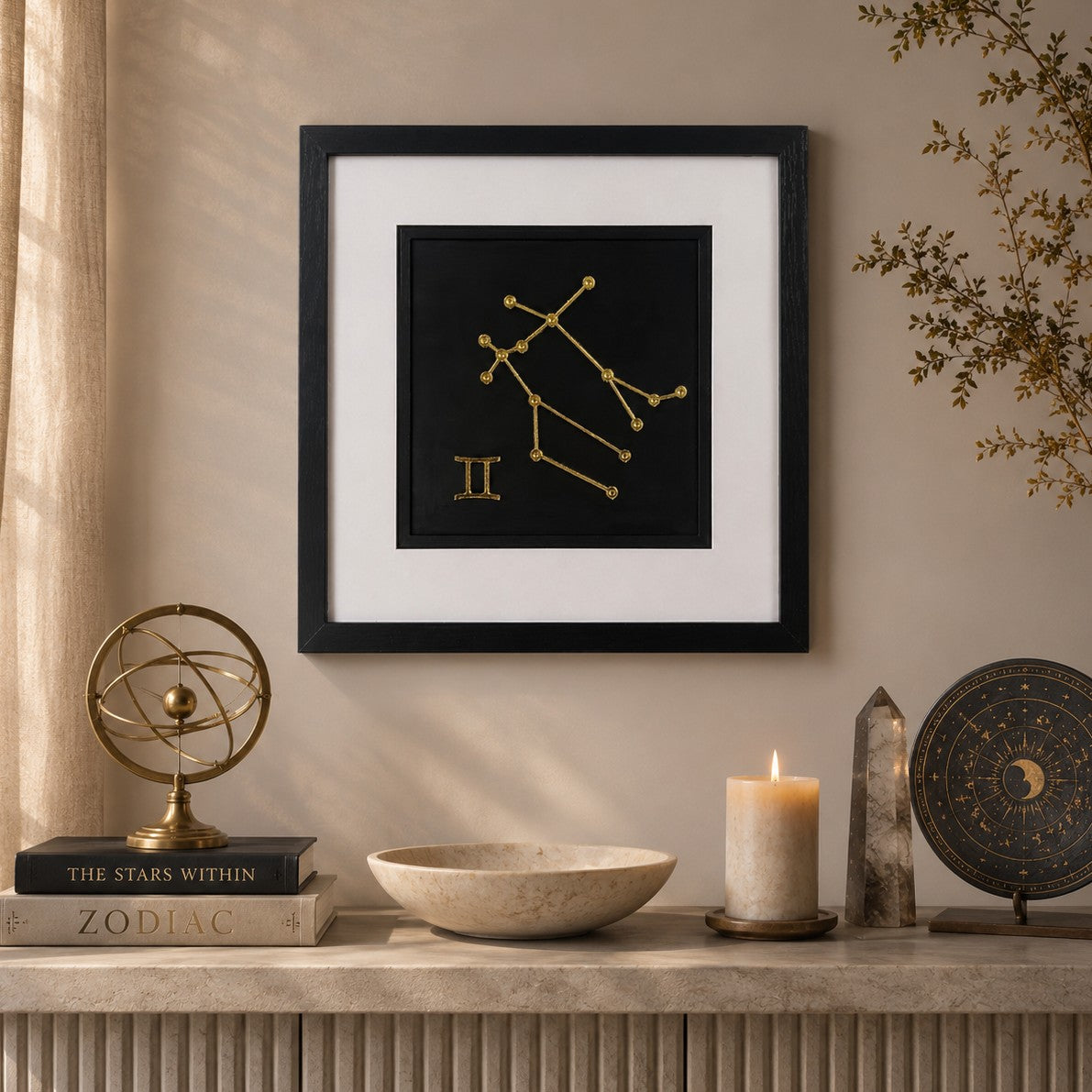 Framed Gemini zodiac wall art with gold constellation design on a black background, styled in a calm neutral interior with celestial decor, candle and elegant astrology-inspired accessories.