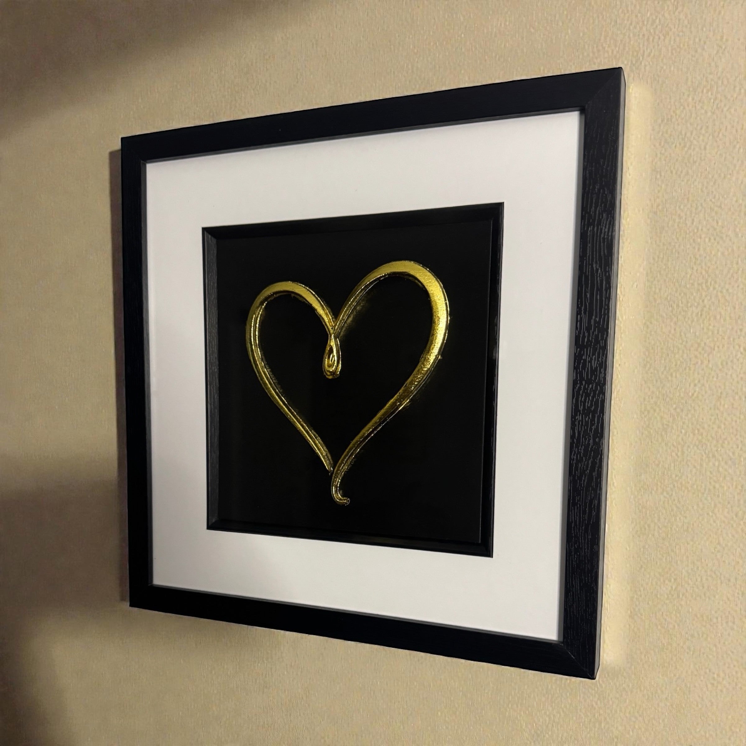 Wall-mounted gold leaf single line love heart framed wall art with white mount
