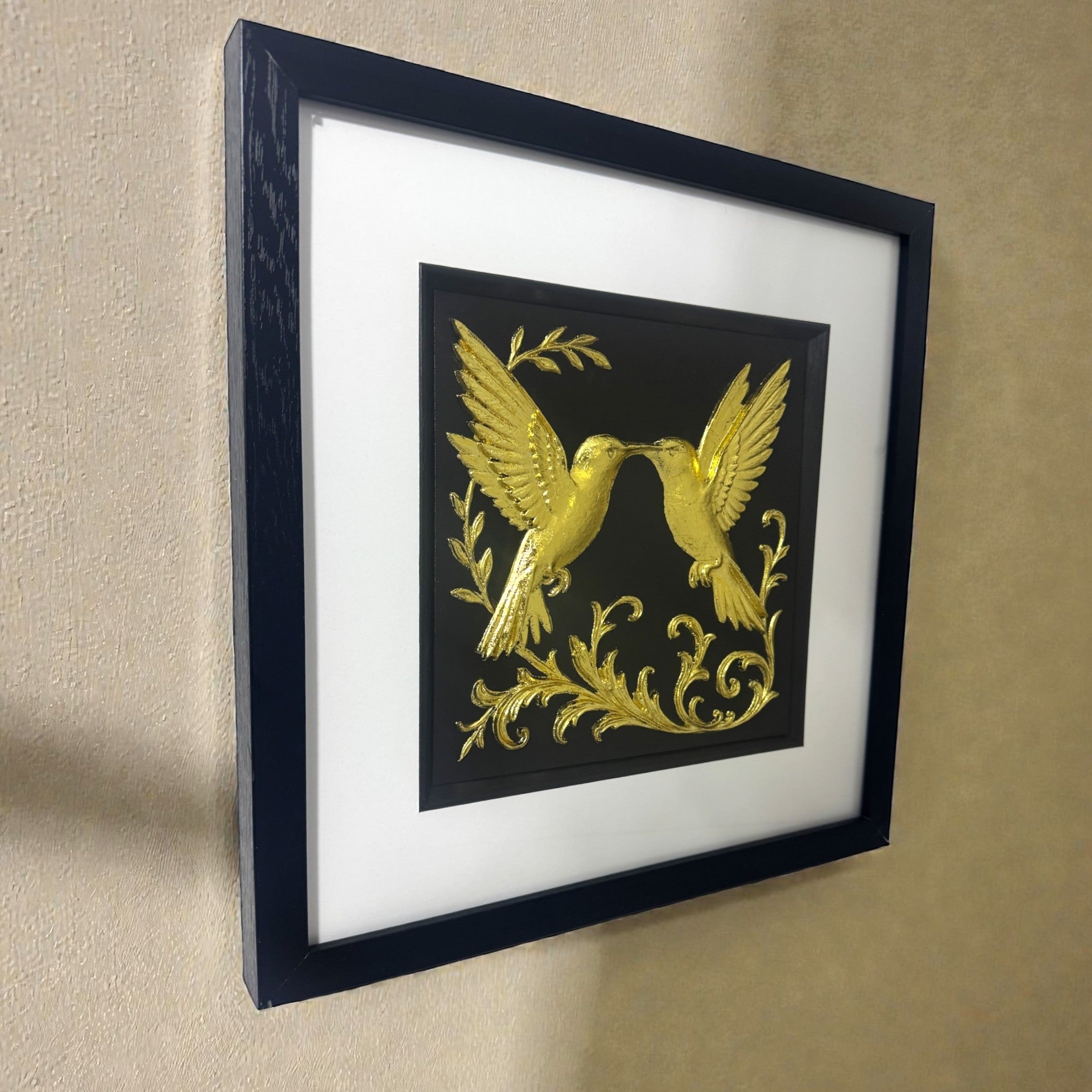 Side view of gold 3D printed hummingbird art showing raised relief texture and metallic shine. Hand-finished wall hanging for living rooms.