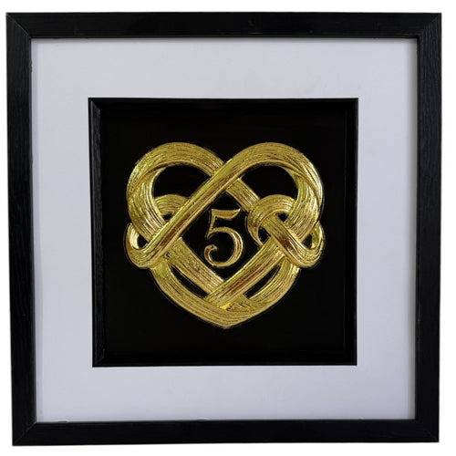 Gold framed 5th wedding anniversary heart knot artwork with central number 5, black box frame, white mount, and black inner surround.