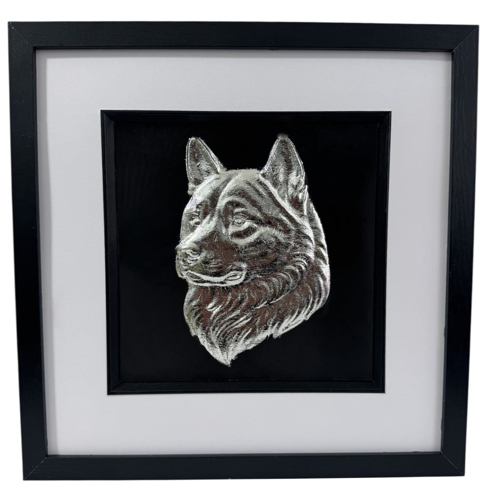 Framed Akita wall art in silver leaf featuring a detailed Akita dog head relief on a black background with white mount and black frame