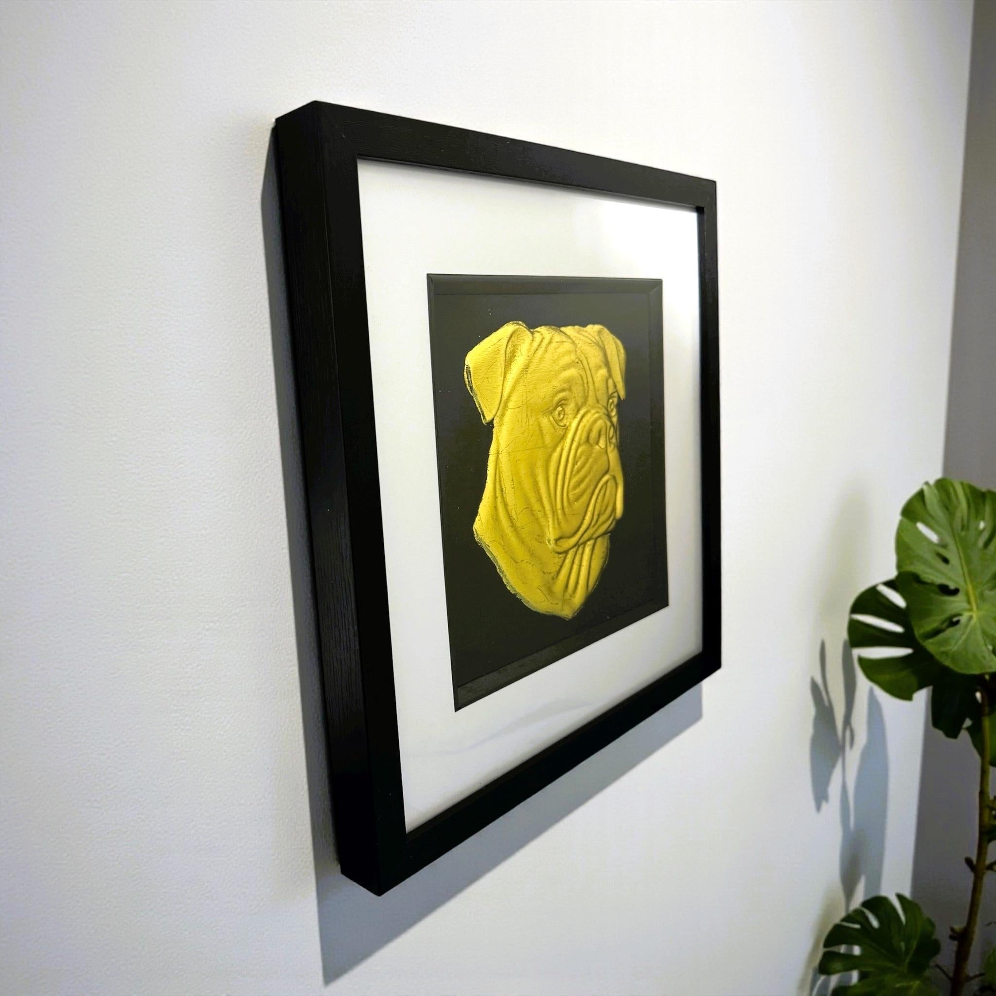 Side view of American Bulldog gold leaf wall art in a black frame mounted on a light coloured wall