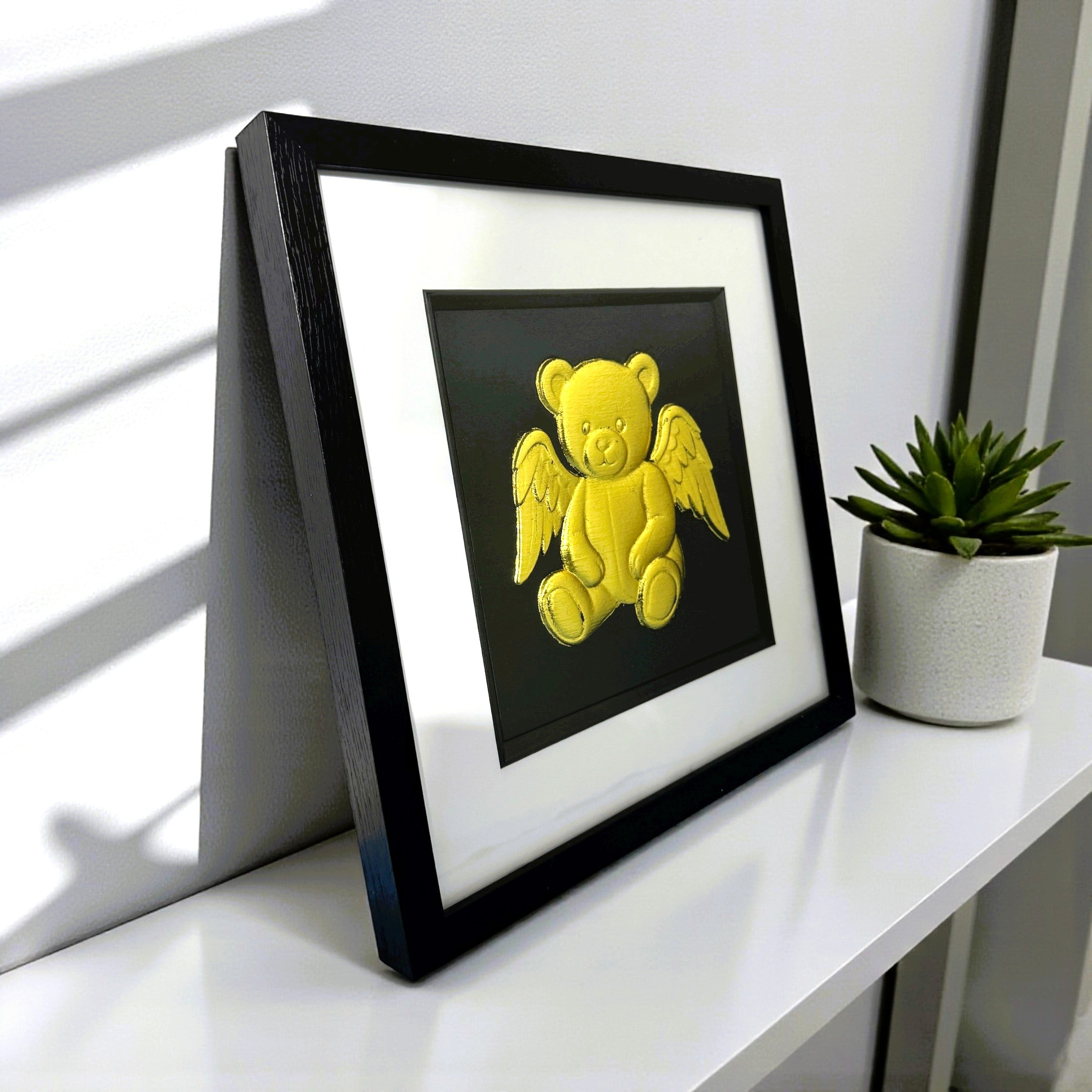 Angel teddy bear gold leaf wall art styled on shelf