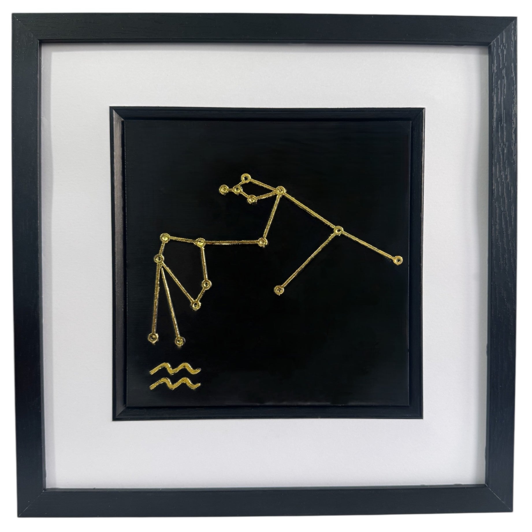 Gold Aquarius constellation wall art framed in black with white mount, raised relief zodiac star pattern on a black background