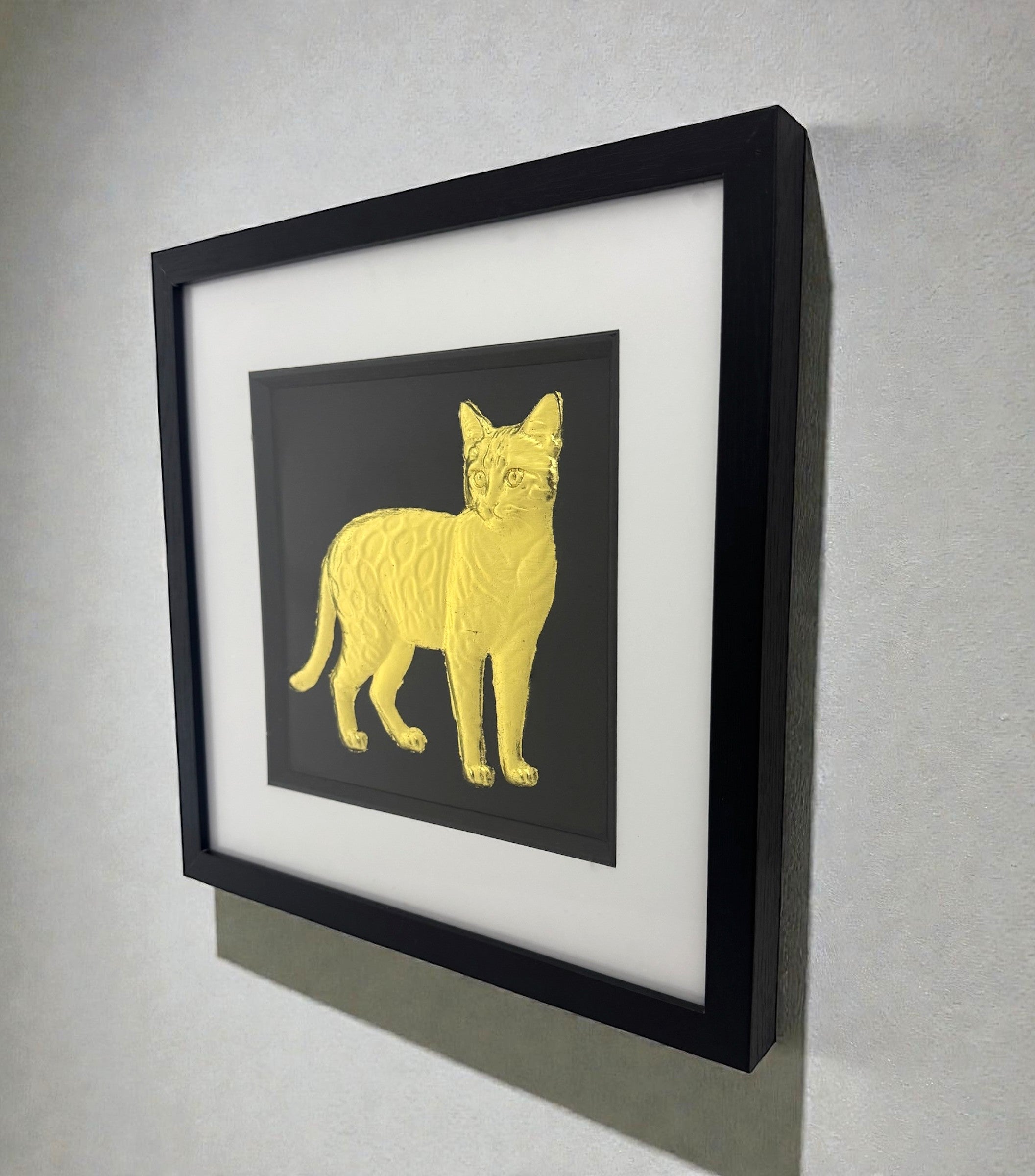 Angled wall view of Bengal cat gold leaf framed wall art showing frame depth and shadow