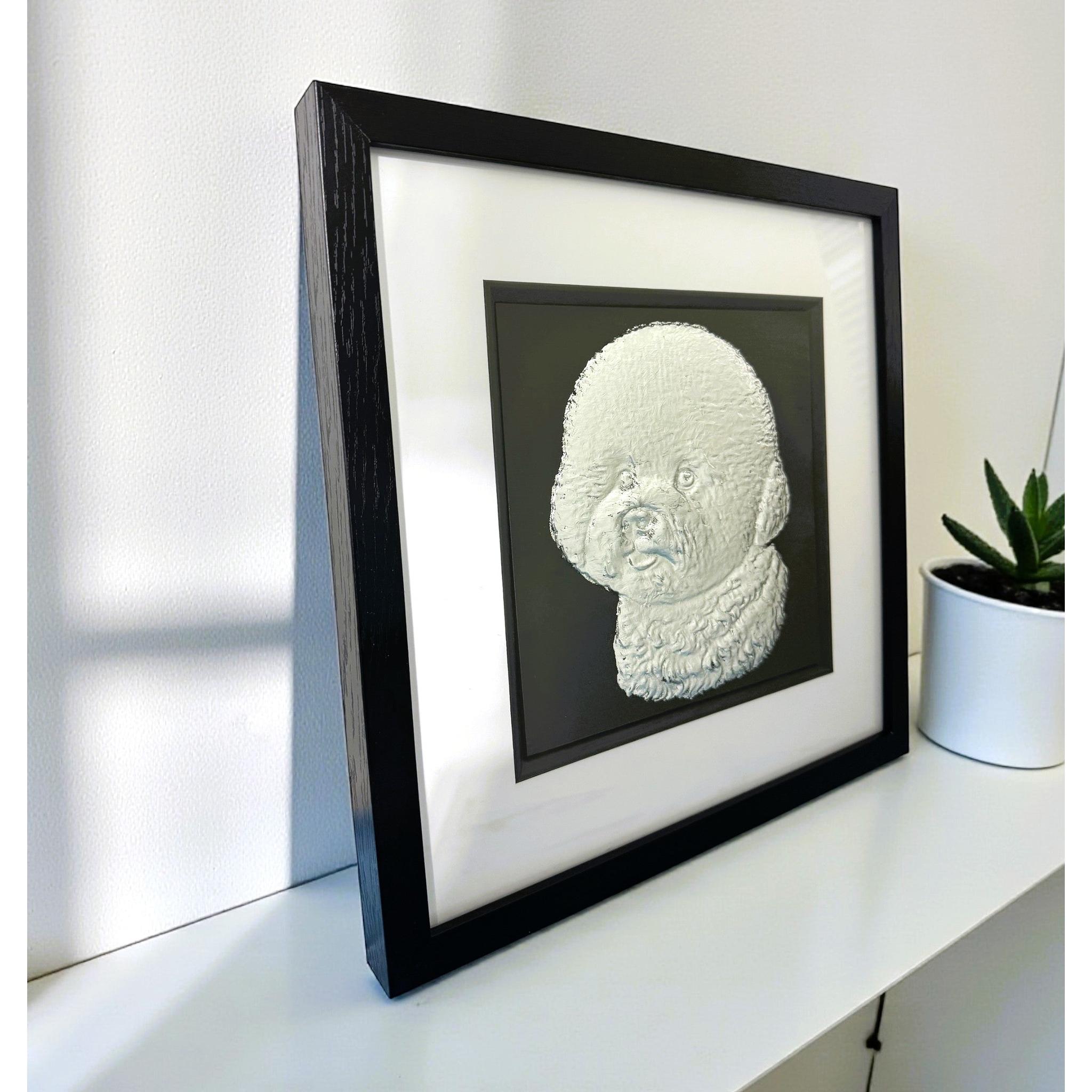 Bichon Frise framed wall art displayed on a modern surface setting