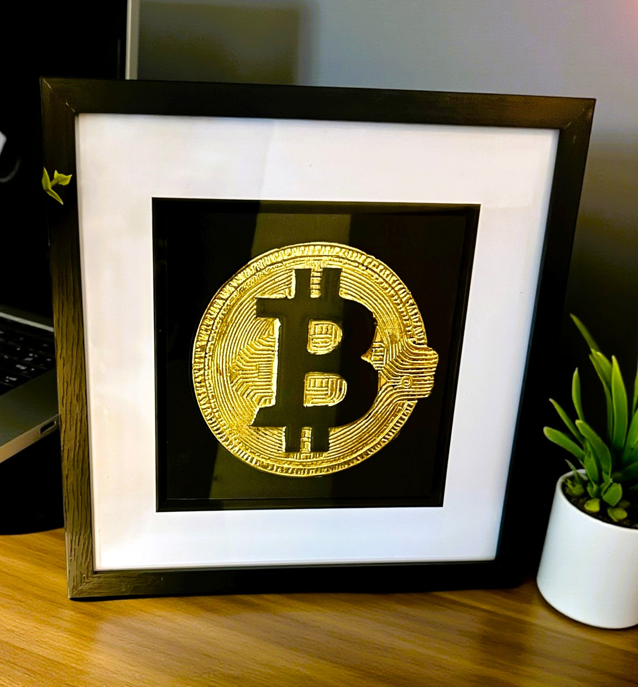 Front view of Bitcoin gold leaf wall art in black frame