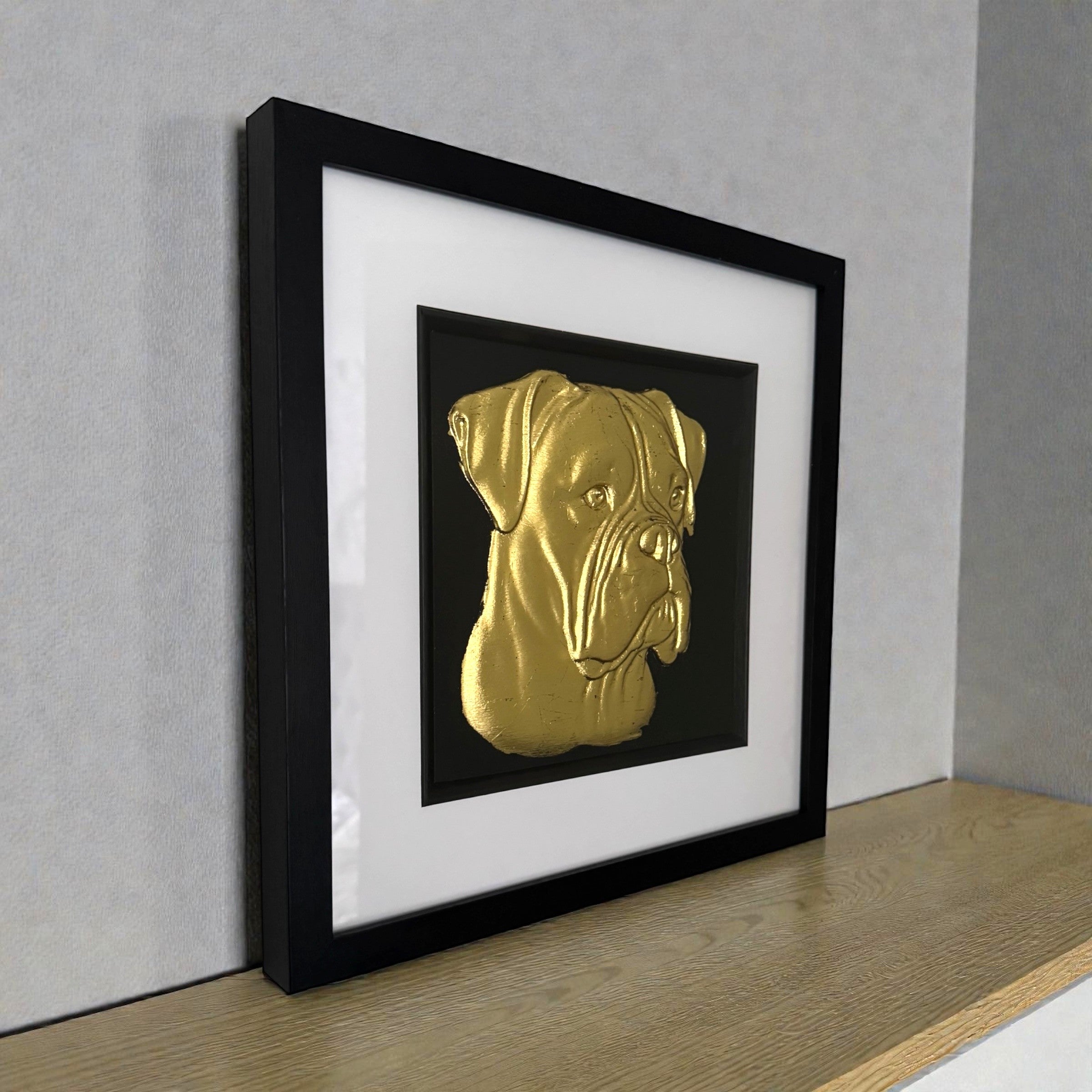 Boxer gold leaf wall art shown from an angled view in black wooden frame
