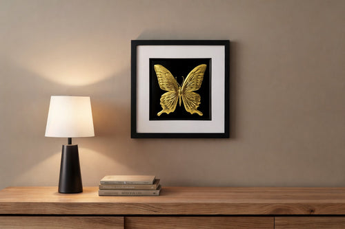 butterfly wall art gold leaf and framed mounted on a beige wall 