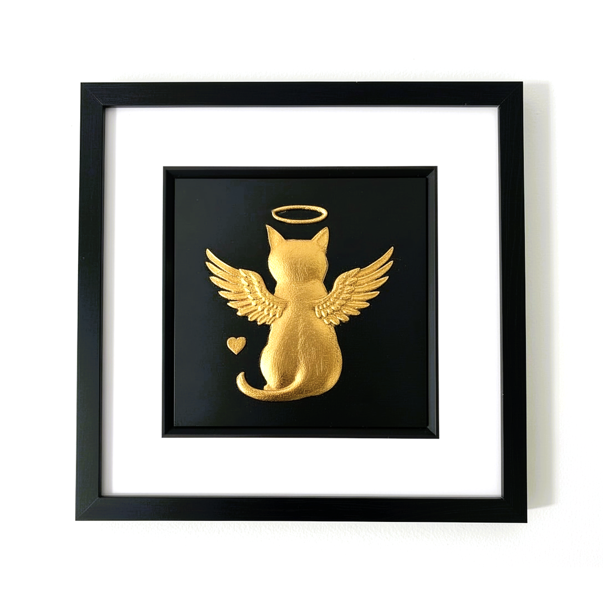 Gold leaf angel cat memorial wall art viewed from the front, framed in black wood with white mount on a black background