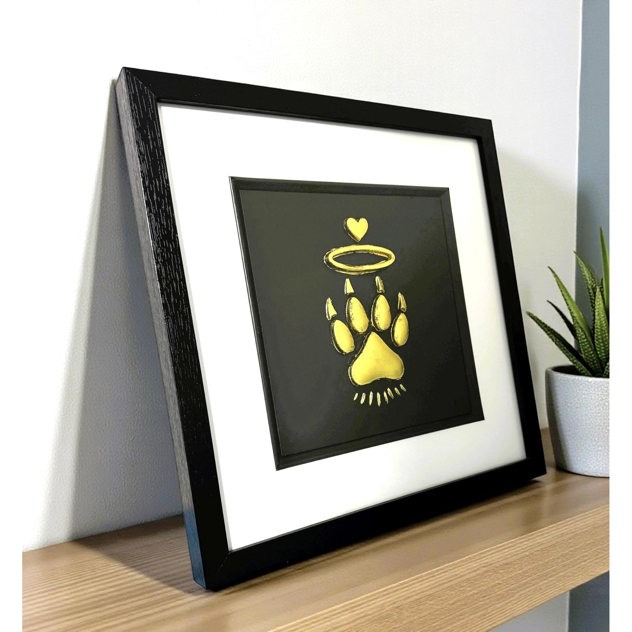 Cat Paw Halo gold leaf framed wall art shown at an angle with black frame and white mount
