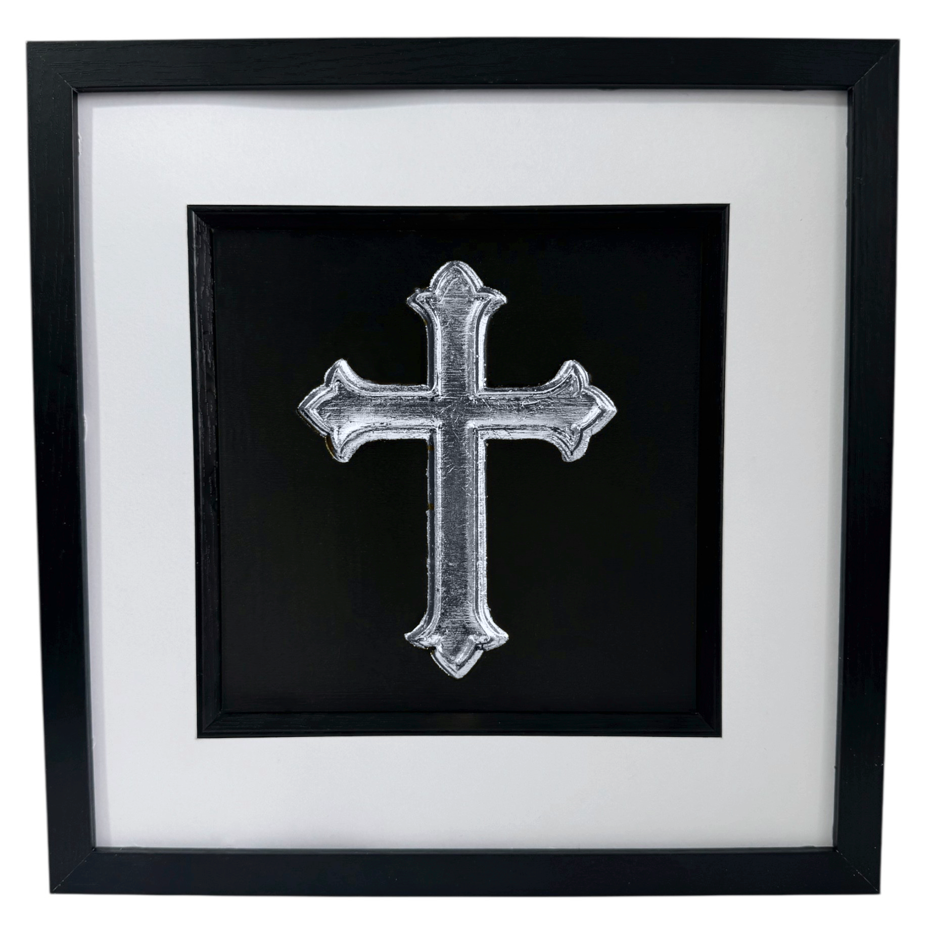 Silver leaf cross wall art framed in black wood with white mount, shown straight on against a neutral wall