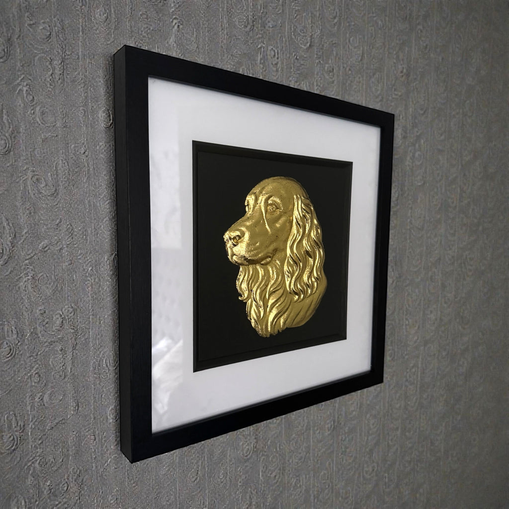 Cocker Spaniel framed wall art with gold leaf relief in black frame mounted to a wall