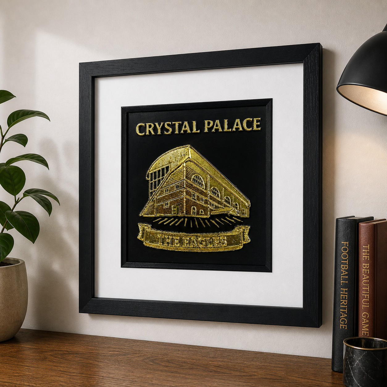 Lifestyle photo of Crystal Palace framed wall art displayed on a wooden surface in a home interior.