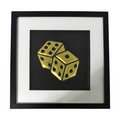 Framed dice wall art in gold leaf relief, centred on a black background with white mount and black frame
