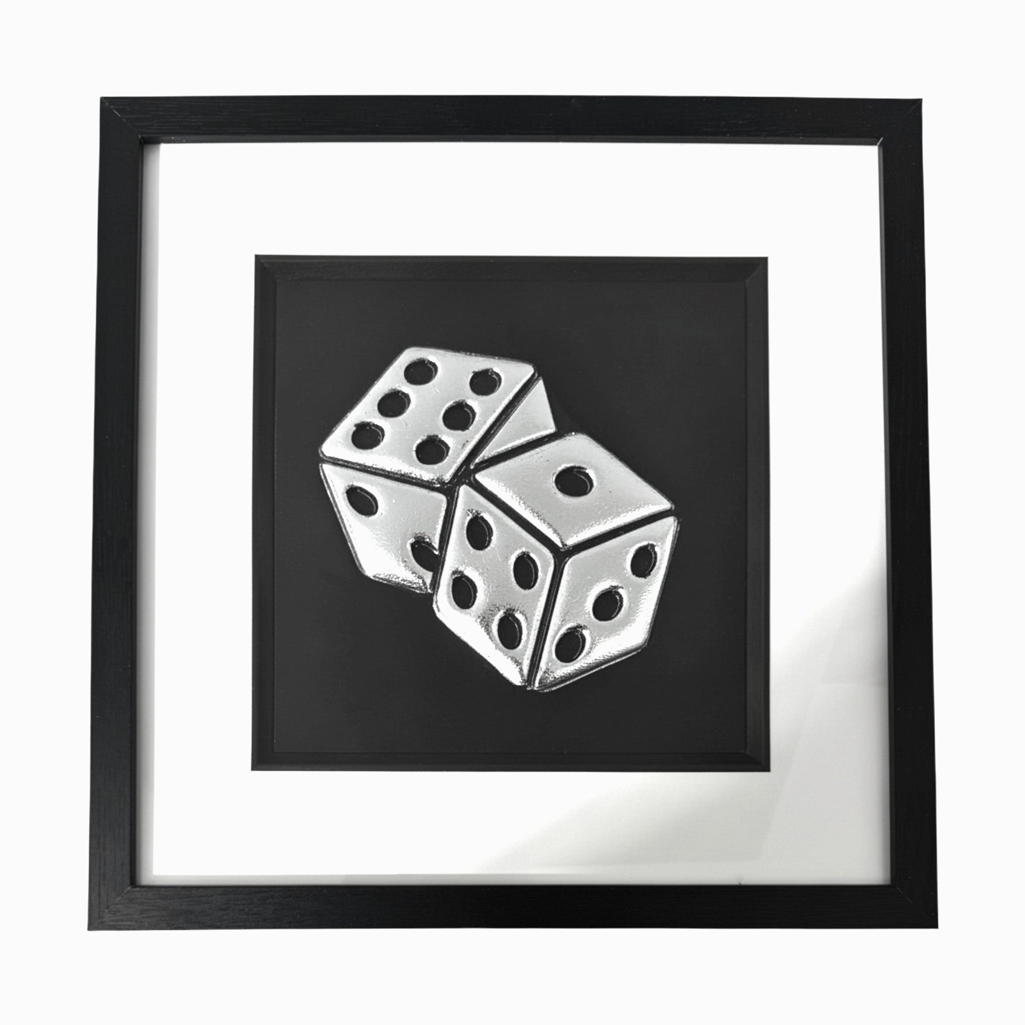 Framed dice wall art in silver leaf relief, centred on a black background with white mount and black frame