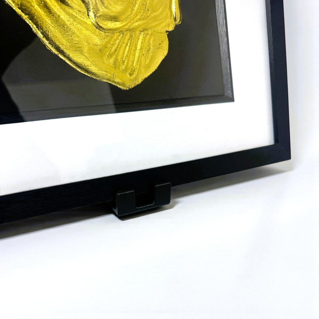 Close-up of black display stand for JP Designs framed wall art