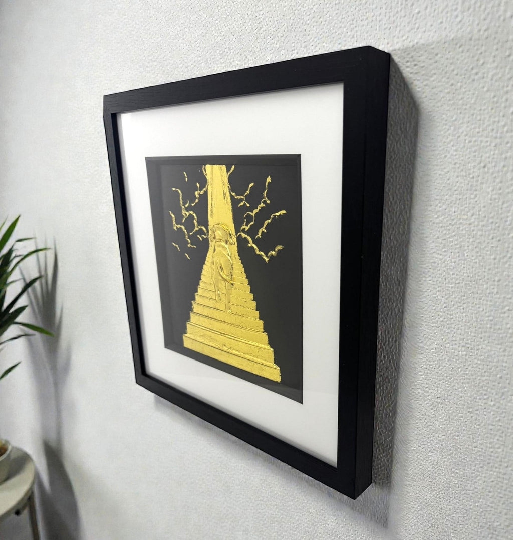 Dog Stairway to Heaven gold leaf wall art displayed on wall with black frame and white mount