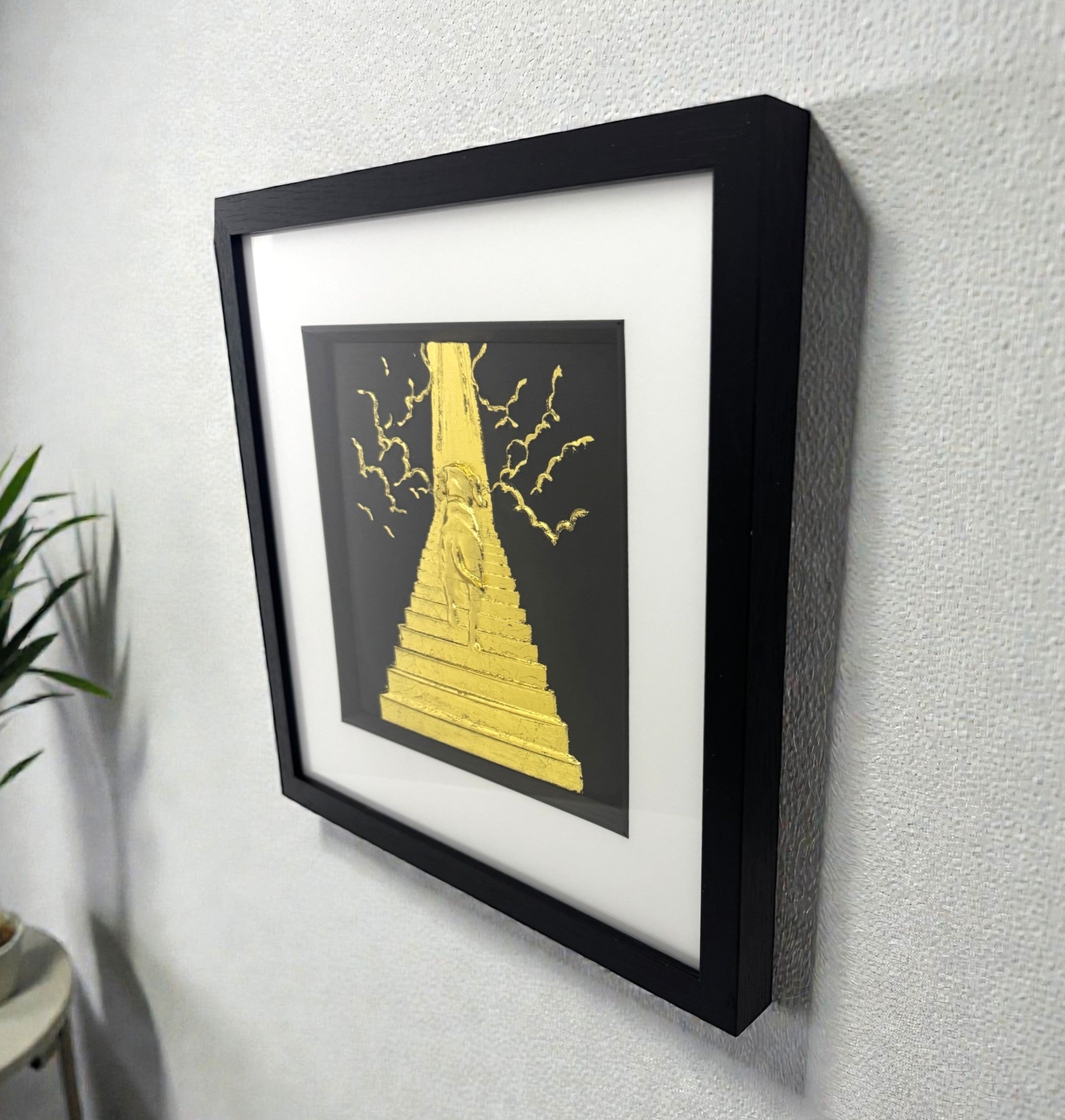 Dog Stairway to Heaven gold leaf wall art displayed on wall with black frame and white mount