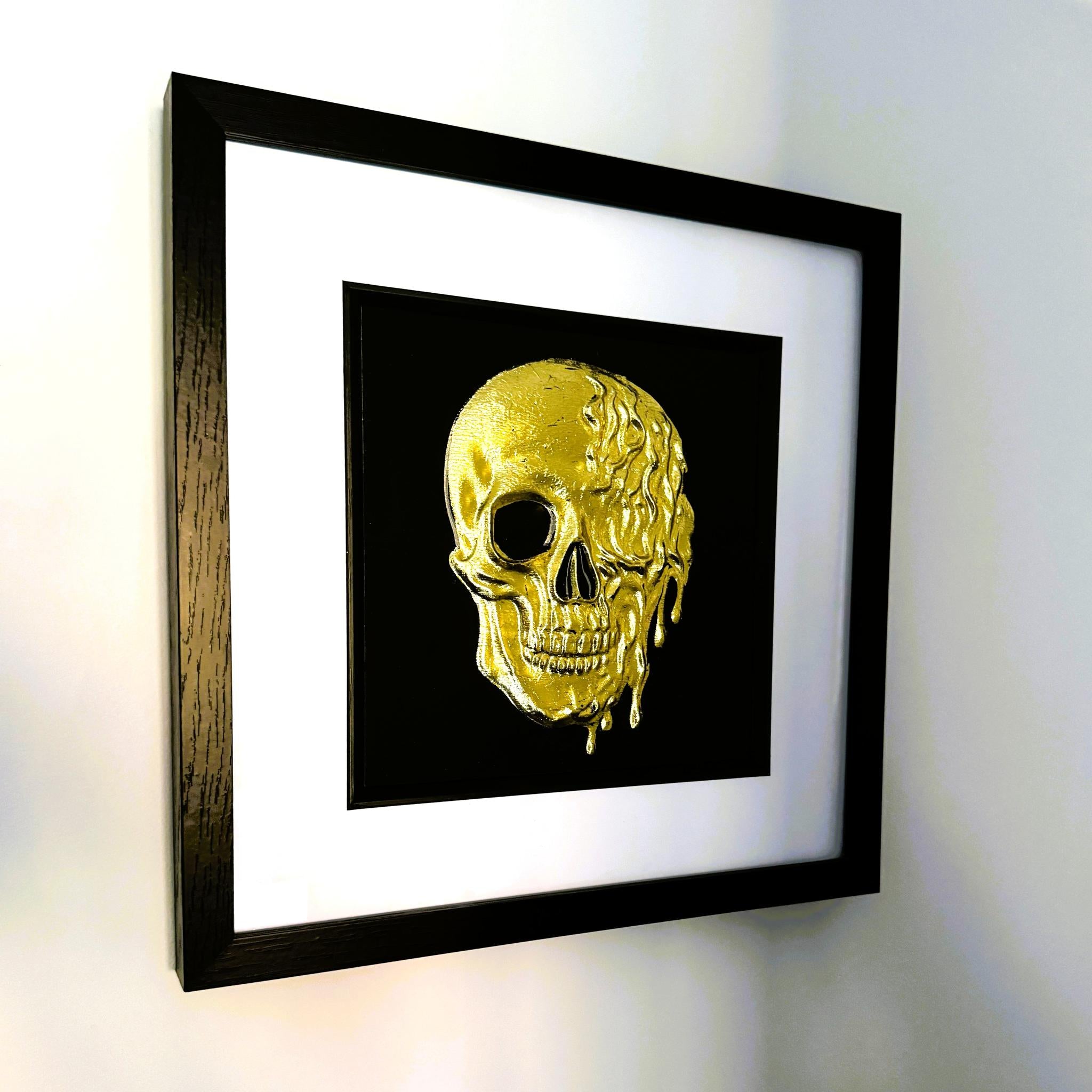 Angled wall view of gold leaf molten dripping skull framed wall art