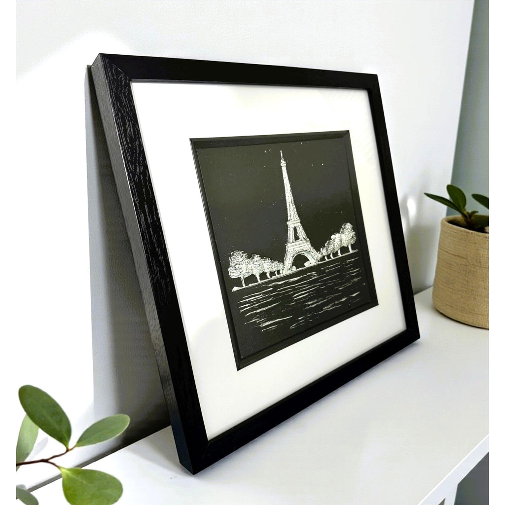 Close-up of Eiffel Tower artwork with reflective water detail