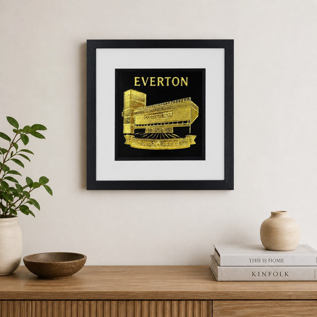Lifestyle photo of Everton FC Goodison Park wall art displayed on a neutral wall above a wooden sideboard.