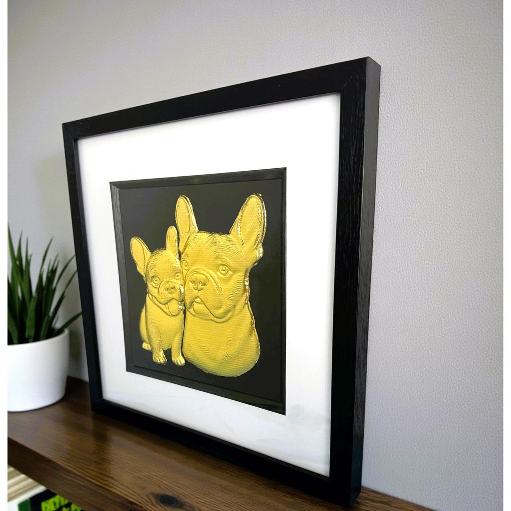 French Bulldog mother and puppy framed wall art in gold leaf viewed at an angle, displayed in a black wooden frame with white mount
