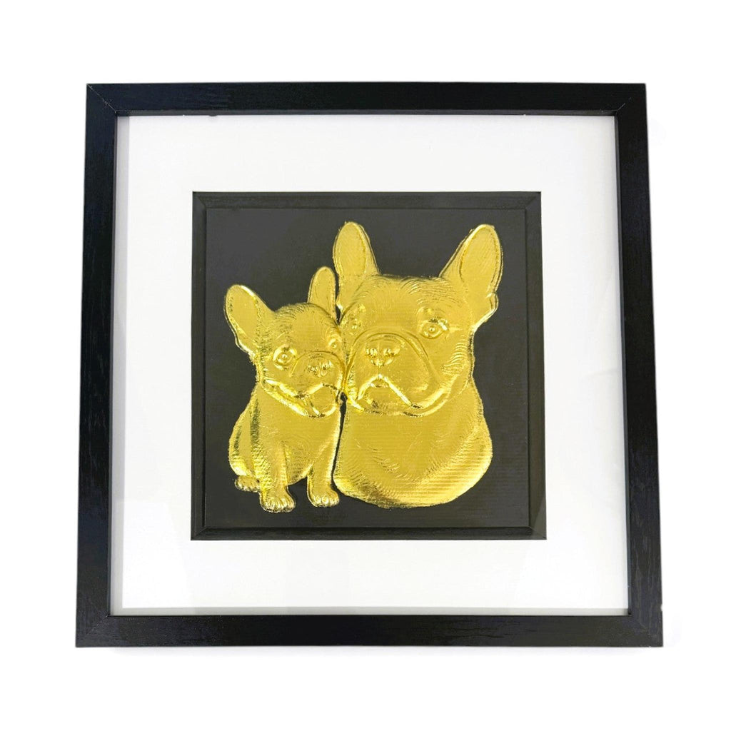 French Bulldog mother and puppy framed wall art showing two sculpted dog portraits in gold leaf, set on a black background with white mount and black wooden frame
