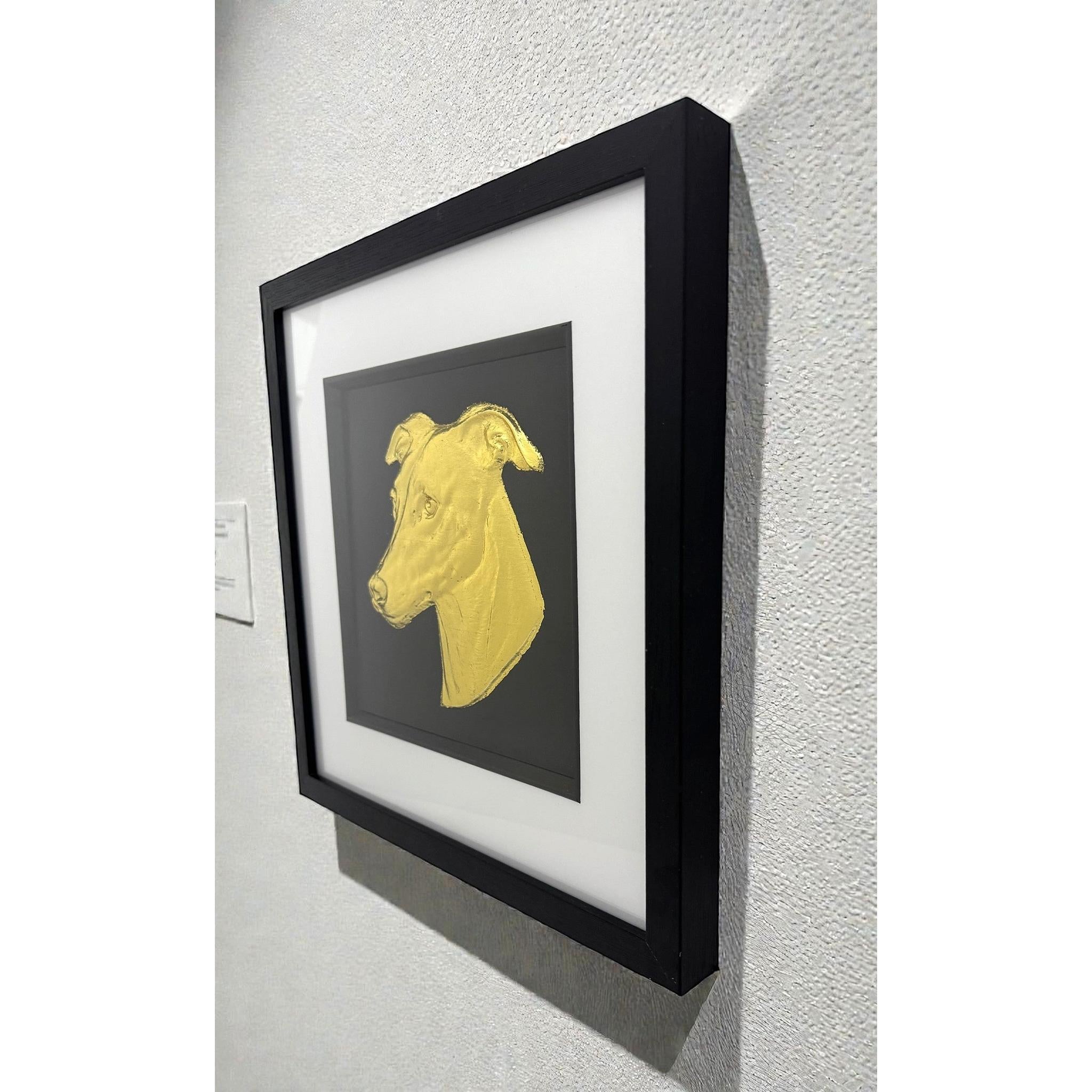 Framed greyhound wall art in gold leaf with black background and white mount