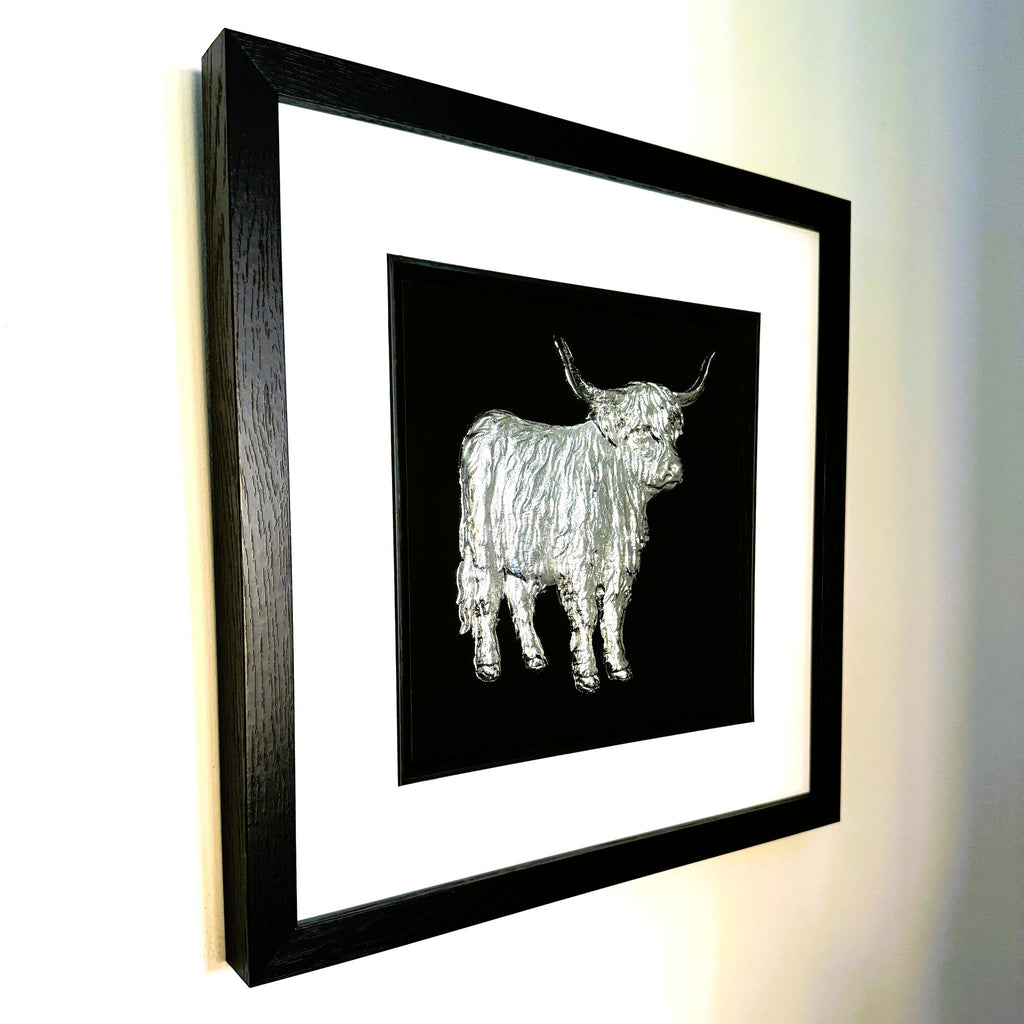 Framed Highland cow wall art shown from an angled wall view