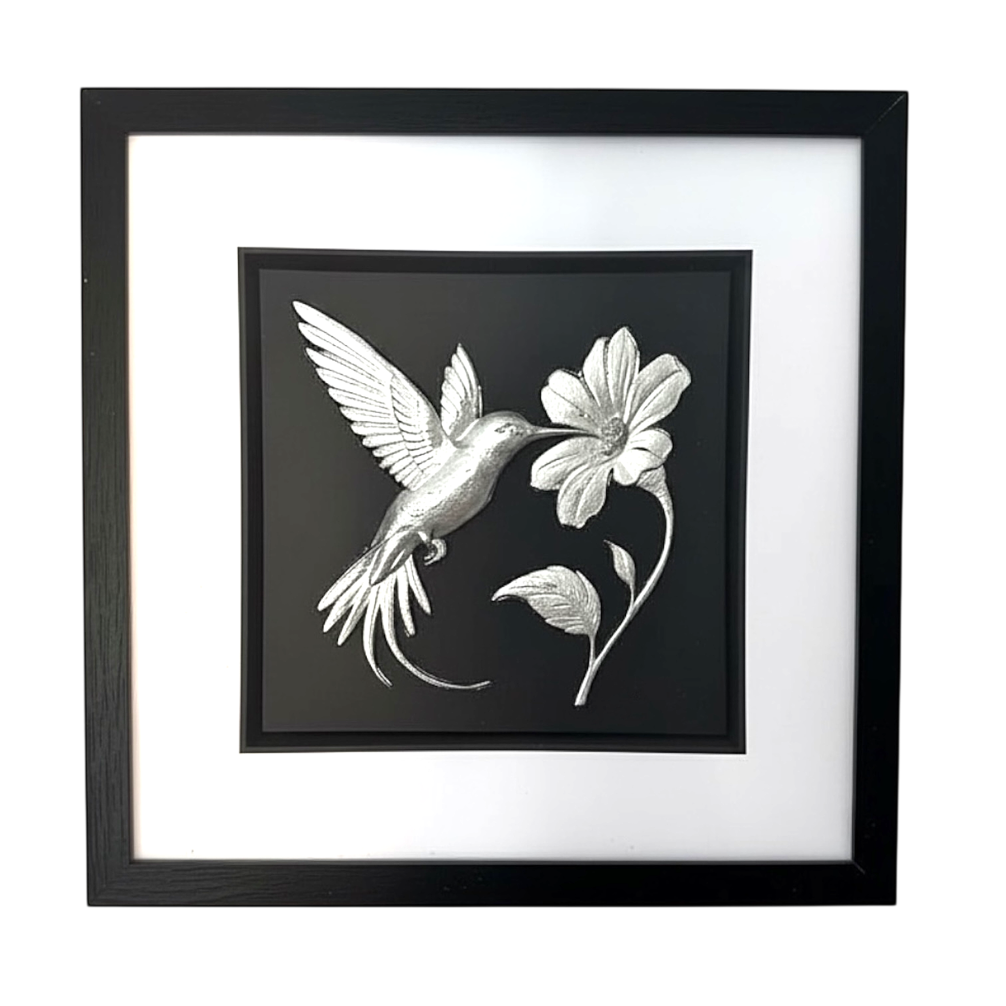 Front-facing silver leaf hummingbird and flower wall art with black background and white mount