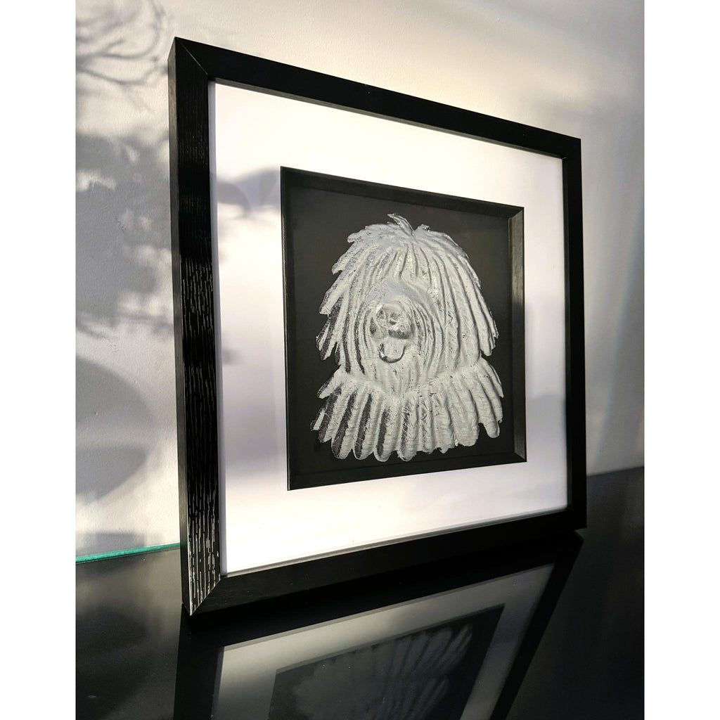 Hungarian Puli framed wall art in silver leaf viewed at an angle, displayed in a black wooden frame with white mount
