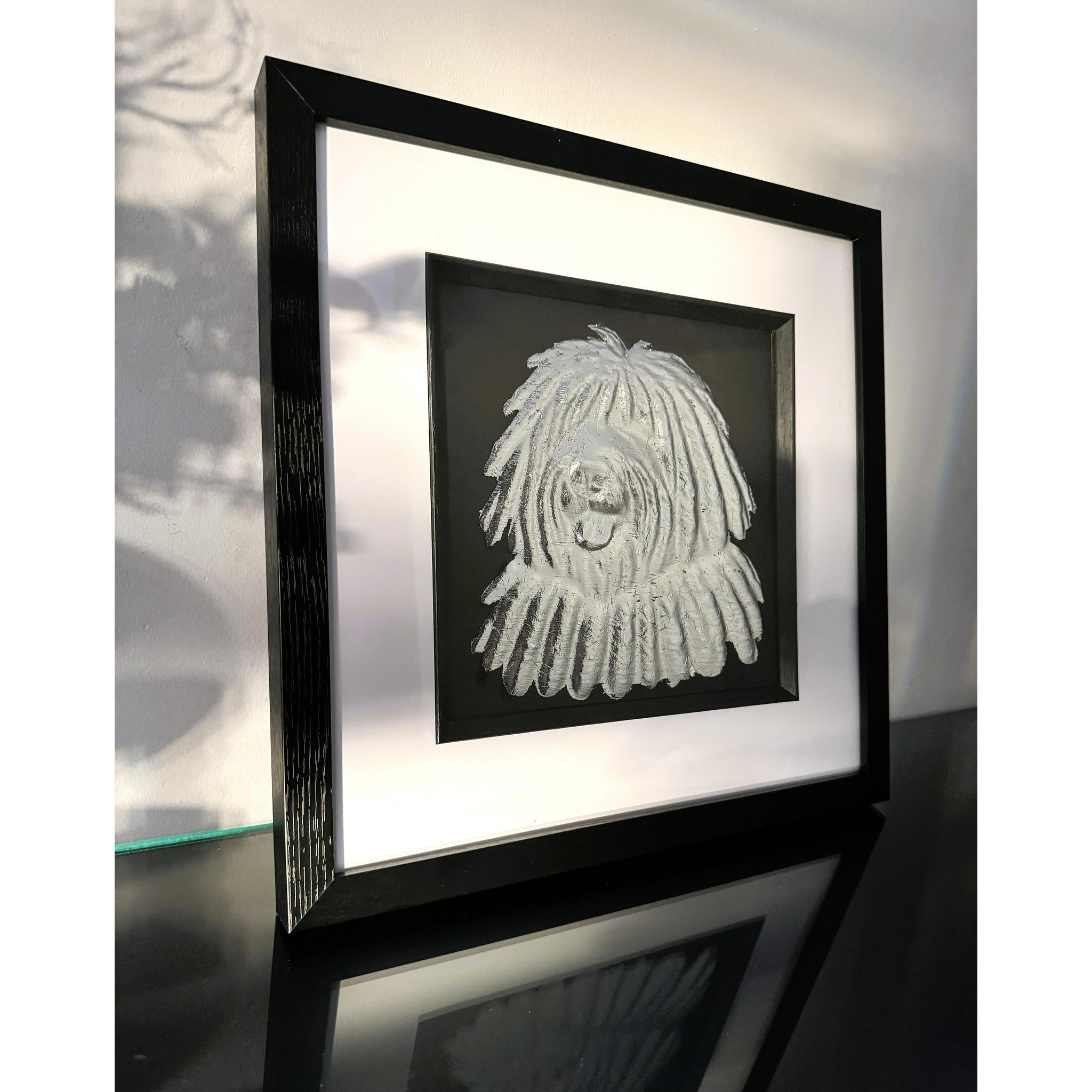Hungarian Puli framed wall art in silver leaf viewed at an angle, displayed in a black wooden frame with white mount
