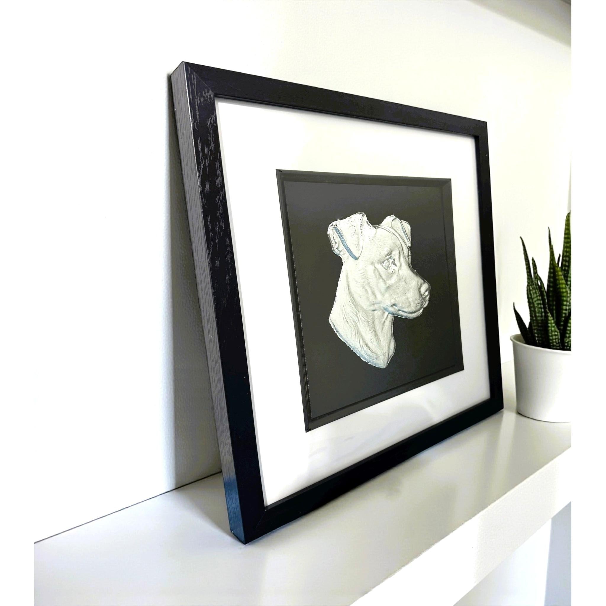 Jack Russell Terrier framed wall art in silver leaf viewed at an angle, displayed in a black wooden frame with white mount
