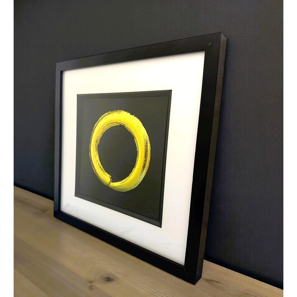 Framed Enso Circle artwork displayed on a shelf in a minimalist interior