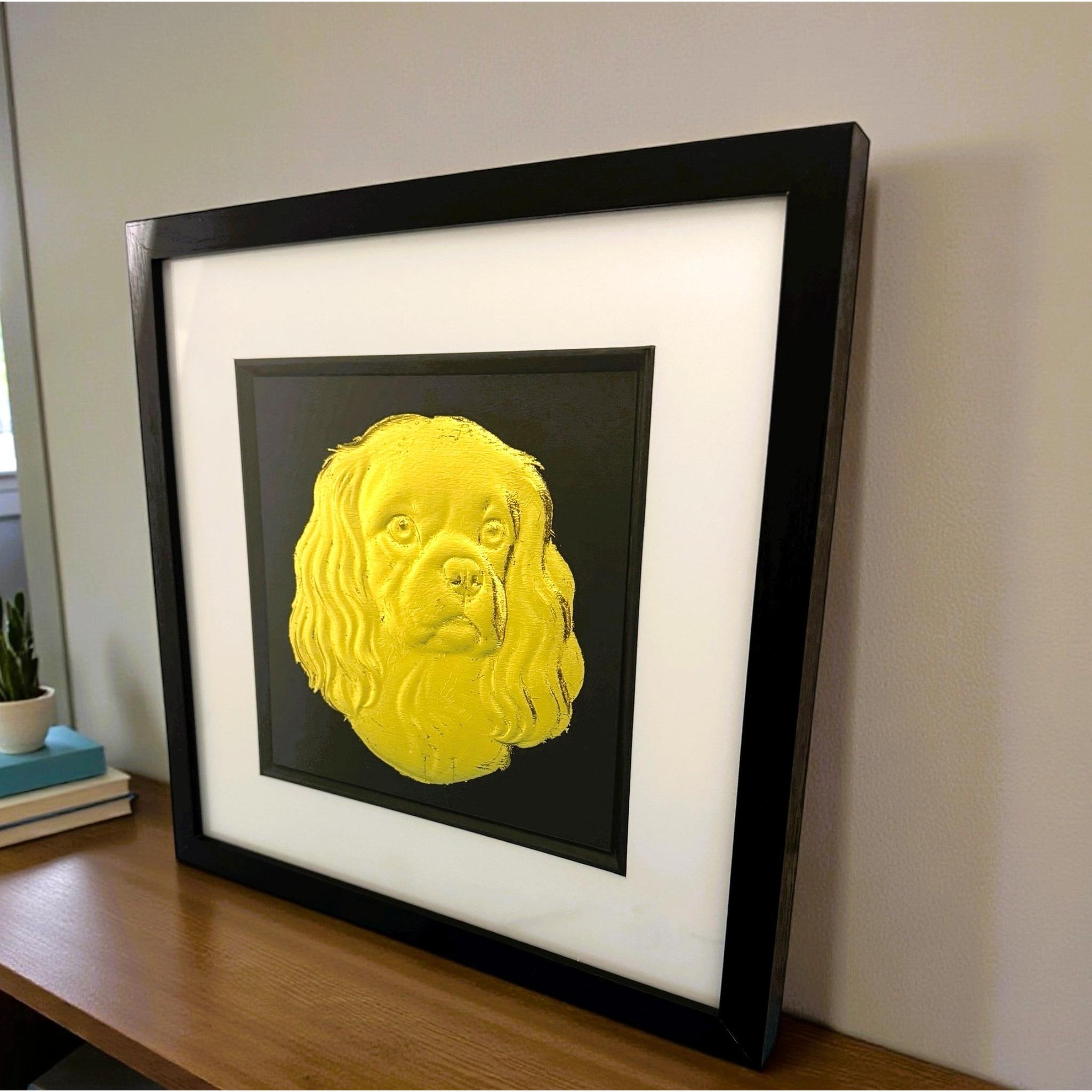 Cavalier King Charles Spaniel framed wall art in gold leaf viewed at an angle, displayed in a black wooden frame with white mount
