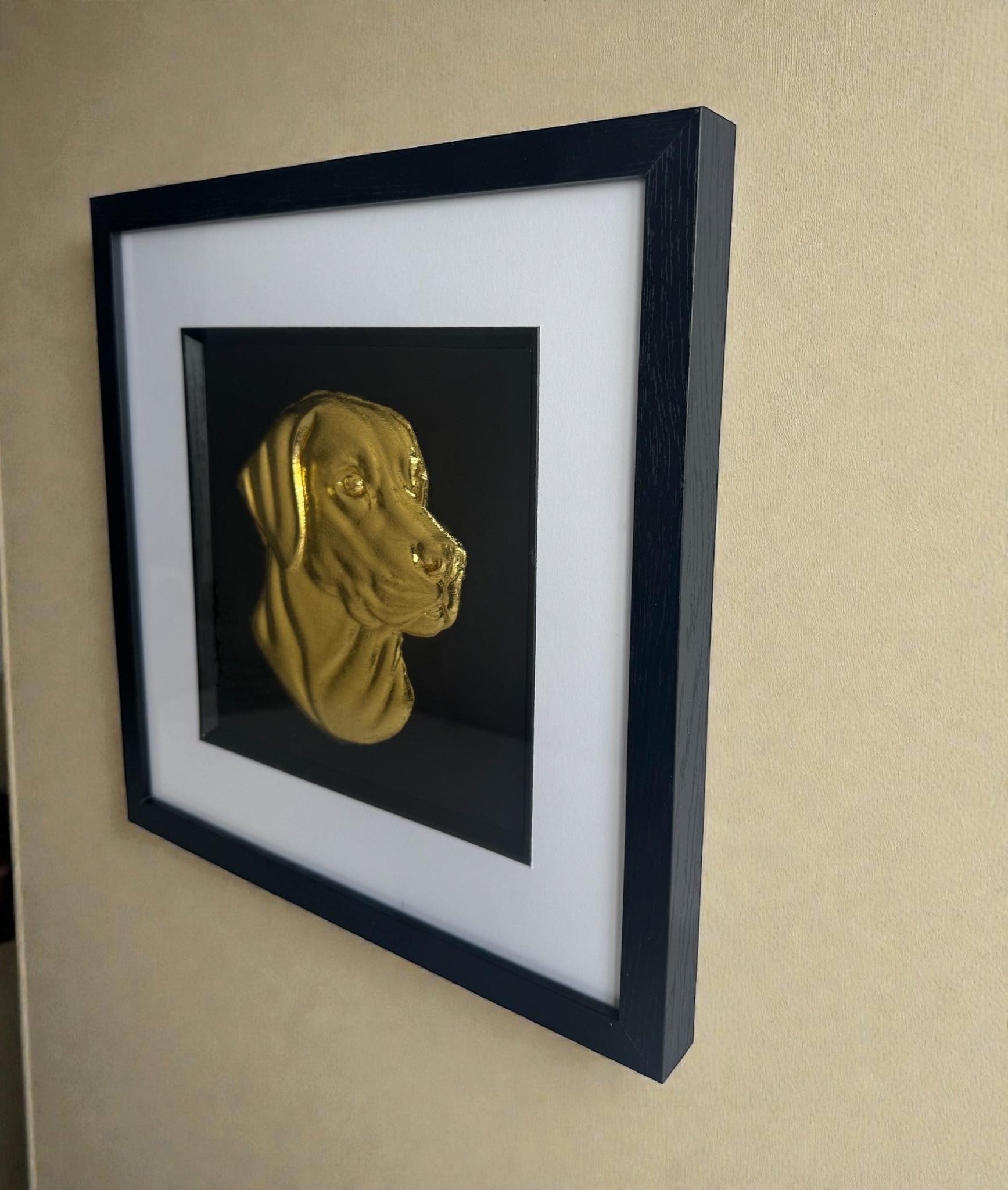 Labrador Retriever framed 3d wall art in gold leaf mounted on a wall, with black wooden frame, white mount, and black background