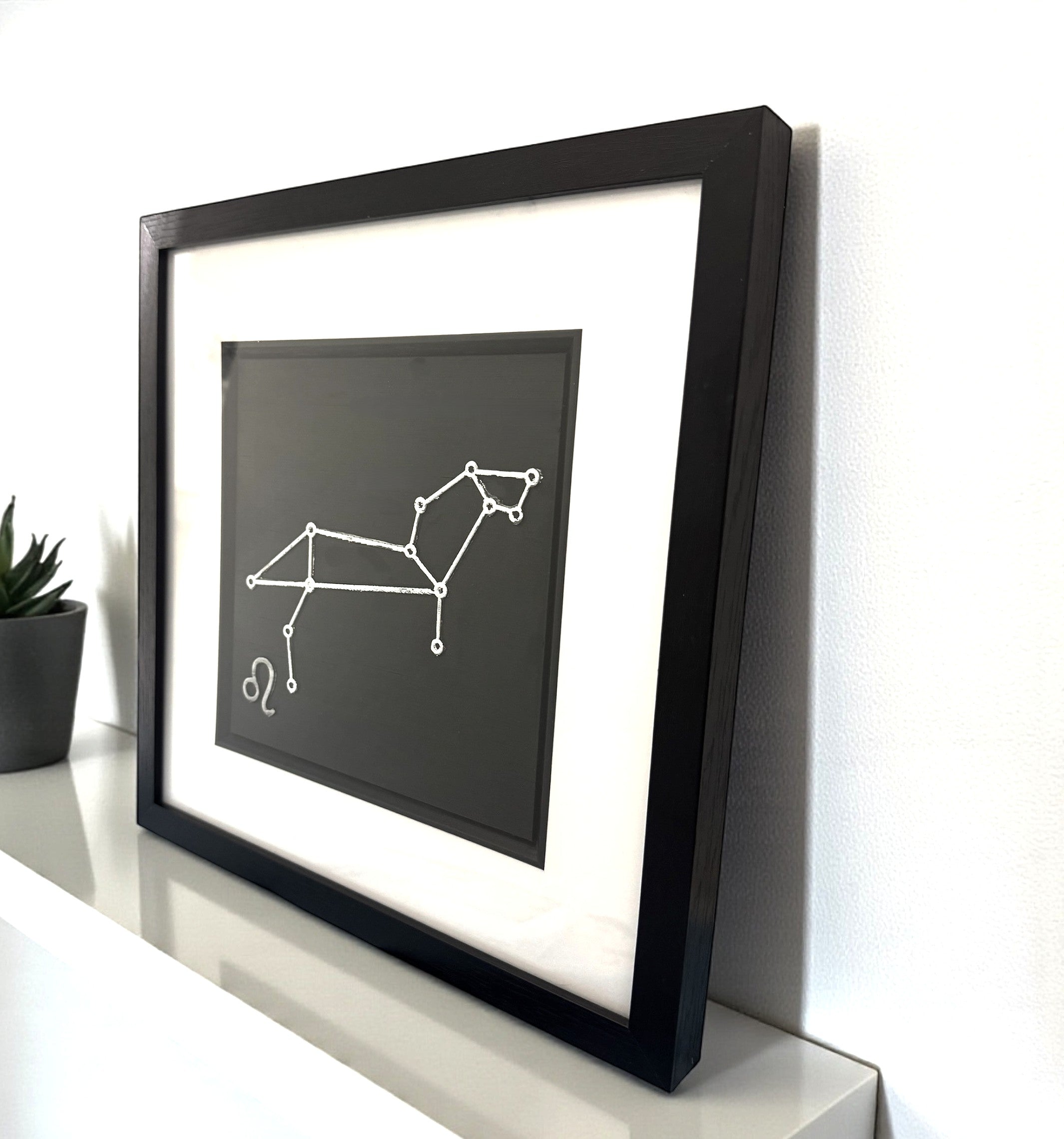 Side view of framed Leo constellation wall art showing depth