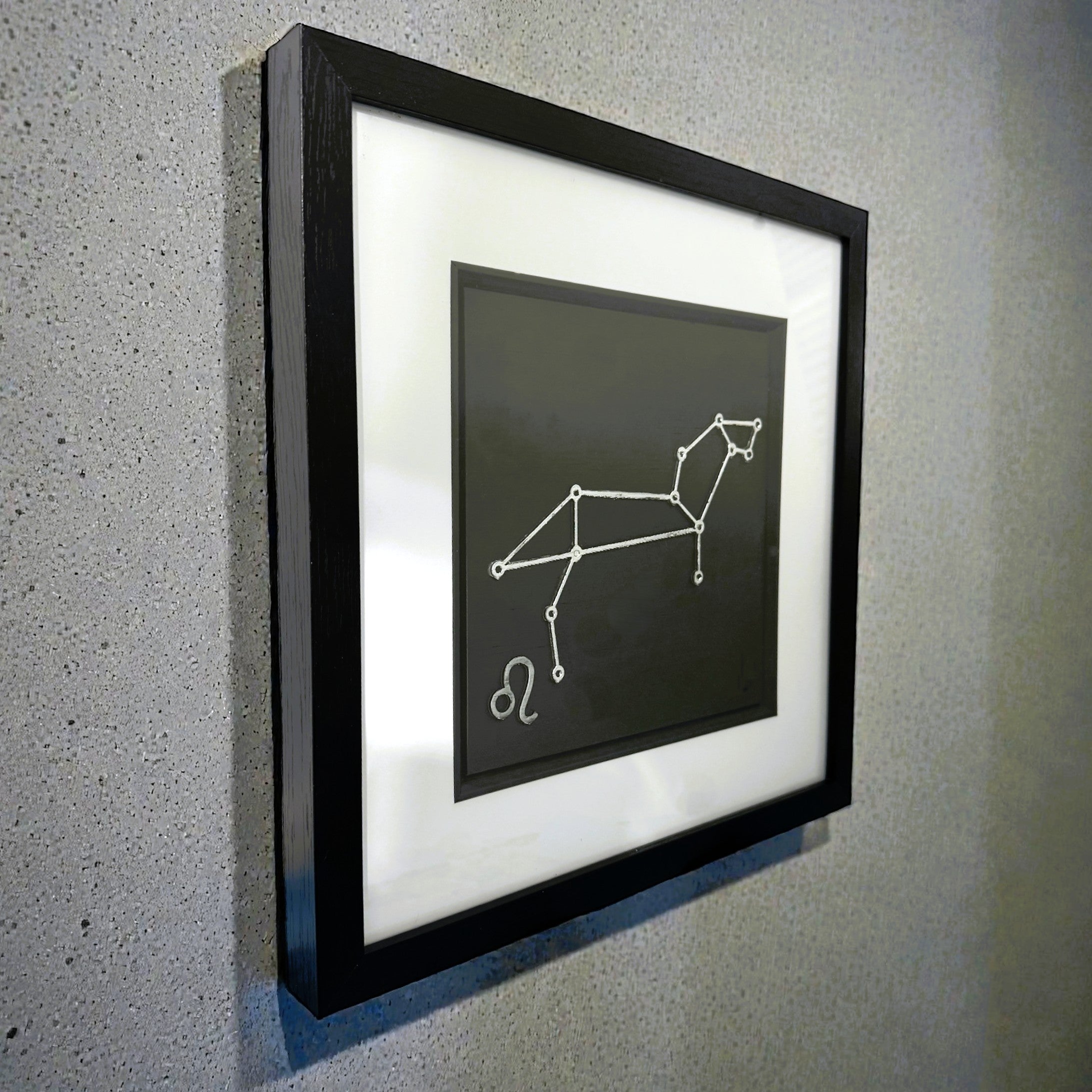 Leo constellation framed wall art displayed on wall