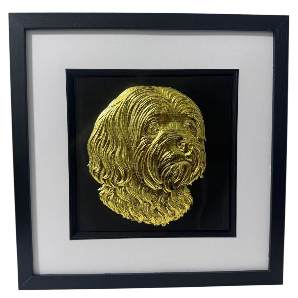 Lhasa Apso framed wall art in gold leaf with black wooden frame and white mount shown at an angled view