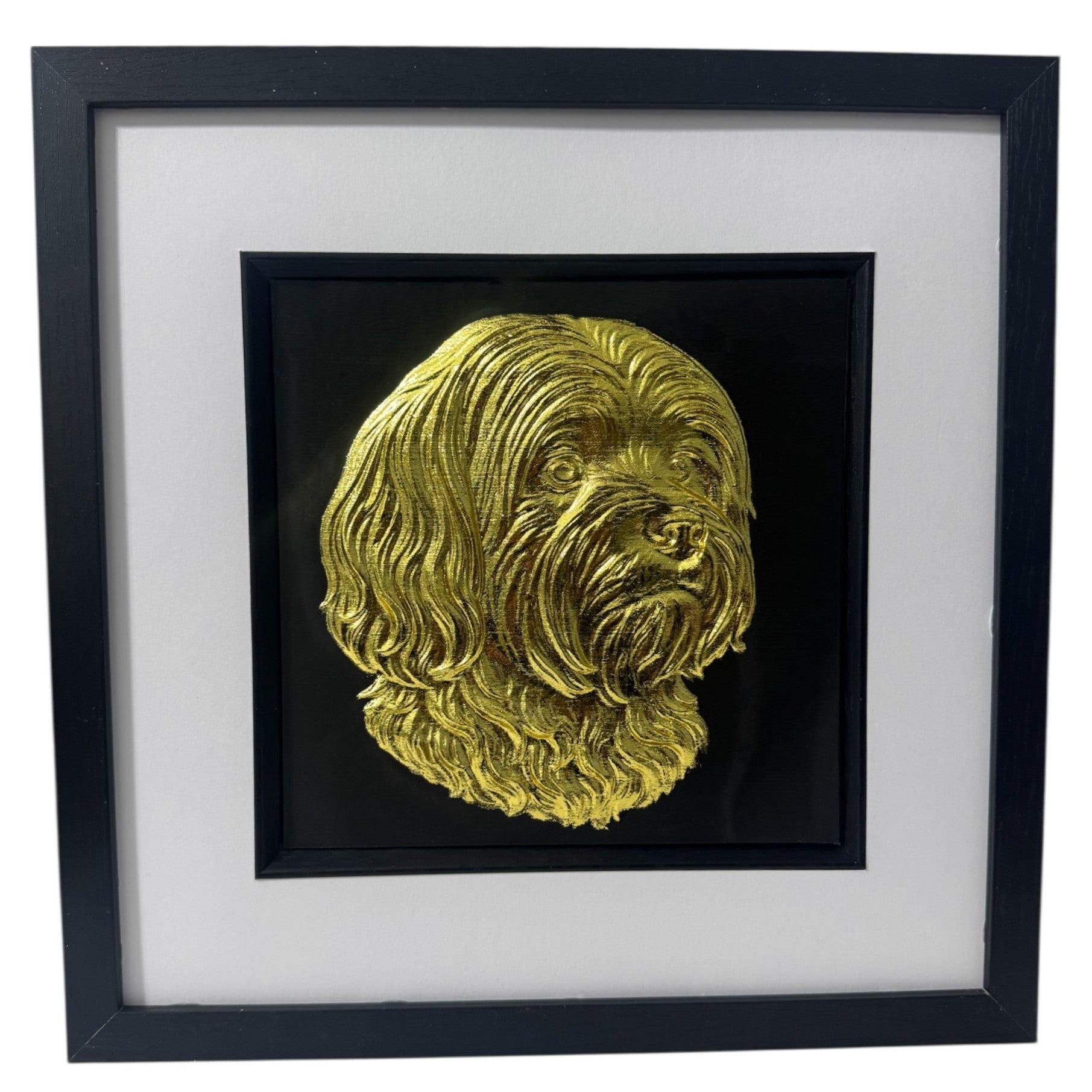 Lhasa Apso framed wall art in gold leaf with black wooden frame and white mount shown at an angled view