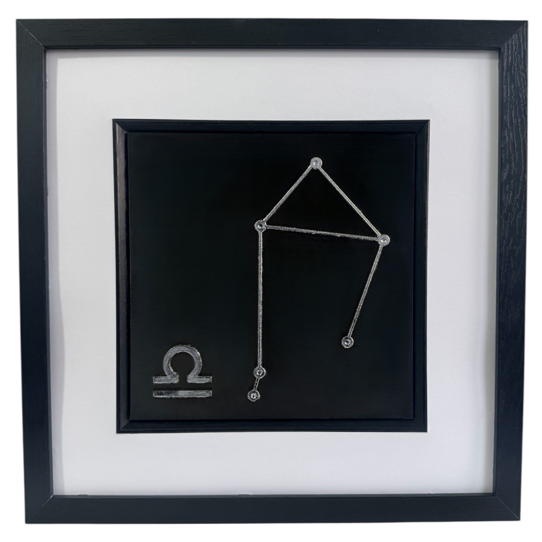 Silver Libra constellation wall art framed in black with white mount, raised relief zodiac star pattern on a black background