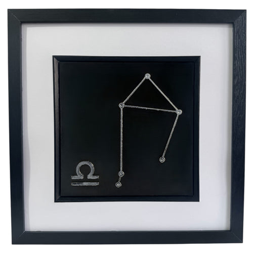Silver Libra constellation wall art framed in black with white mount, raised relief zodiac star pattern on a black background