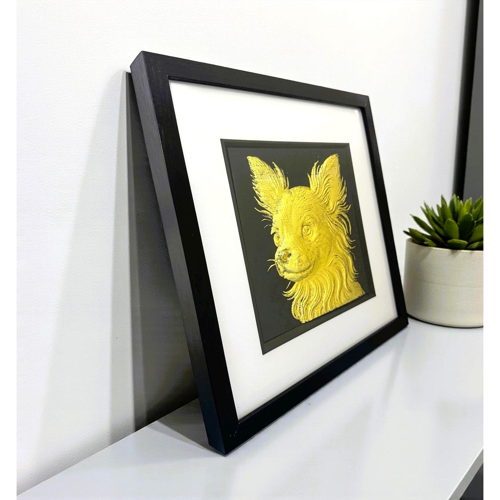 Long Hair Chihuahua gold leaf wall art photographed at an angle on a shelf with black frame and white mount