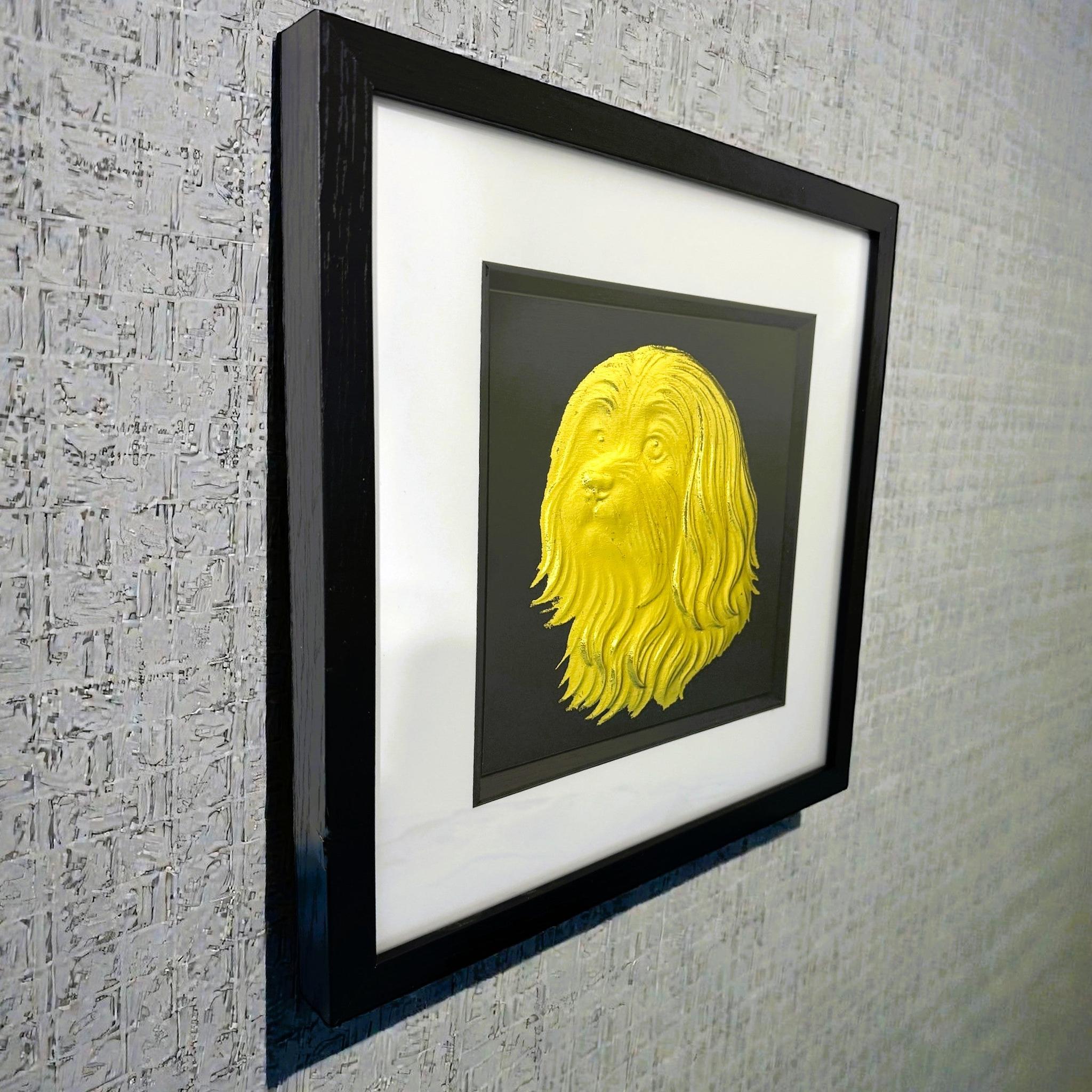 Maltese gold leaf framed wall art mounted on a textured wall shown at a slight angle with black frame and white mount