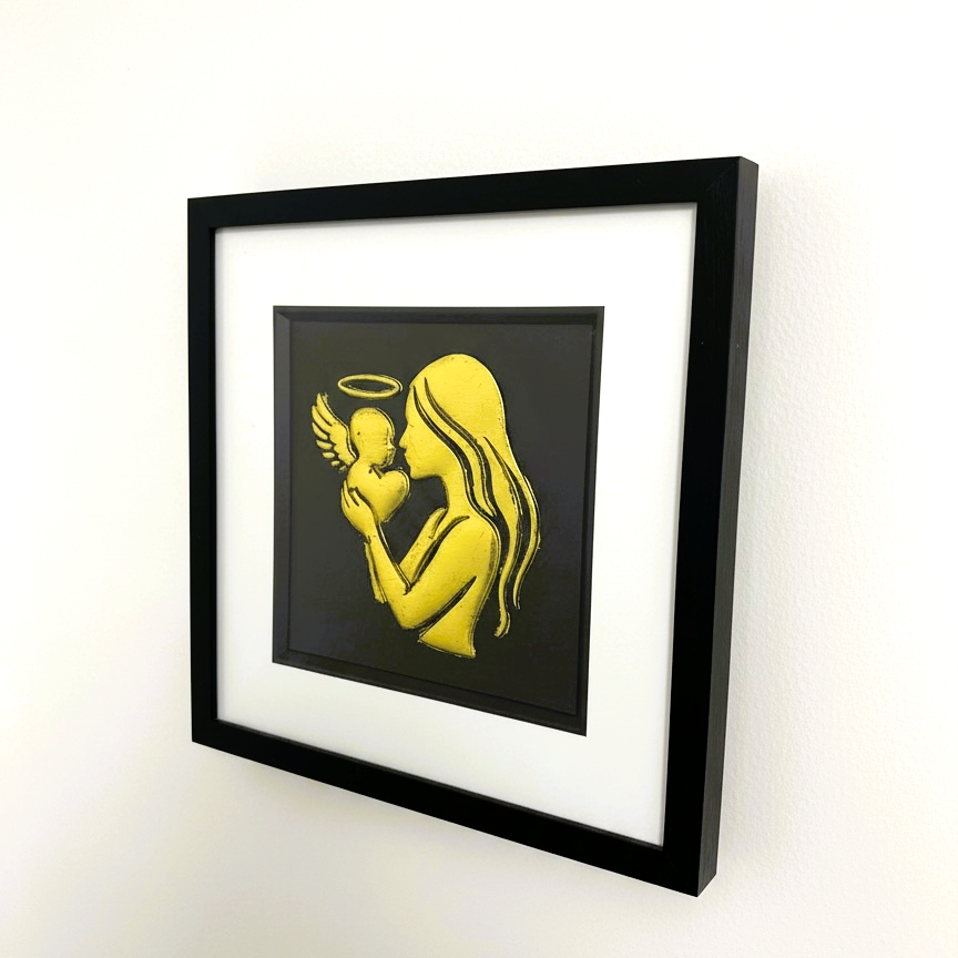 Wall-mounted mother and baby angel wall art framed in black with white mount